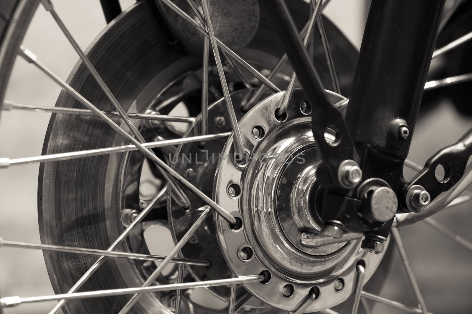 a spoked wheel of a vintage motor cycle