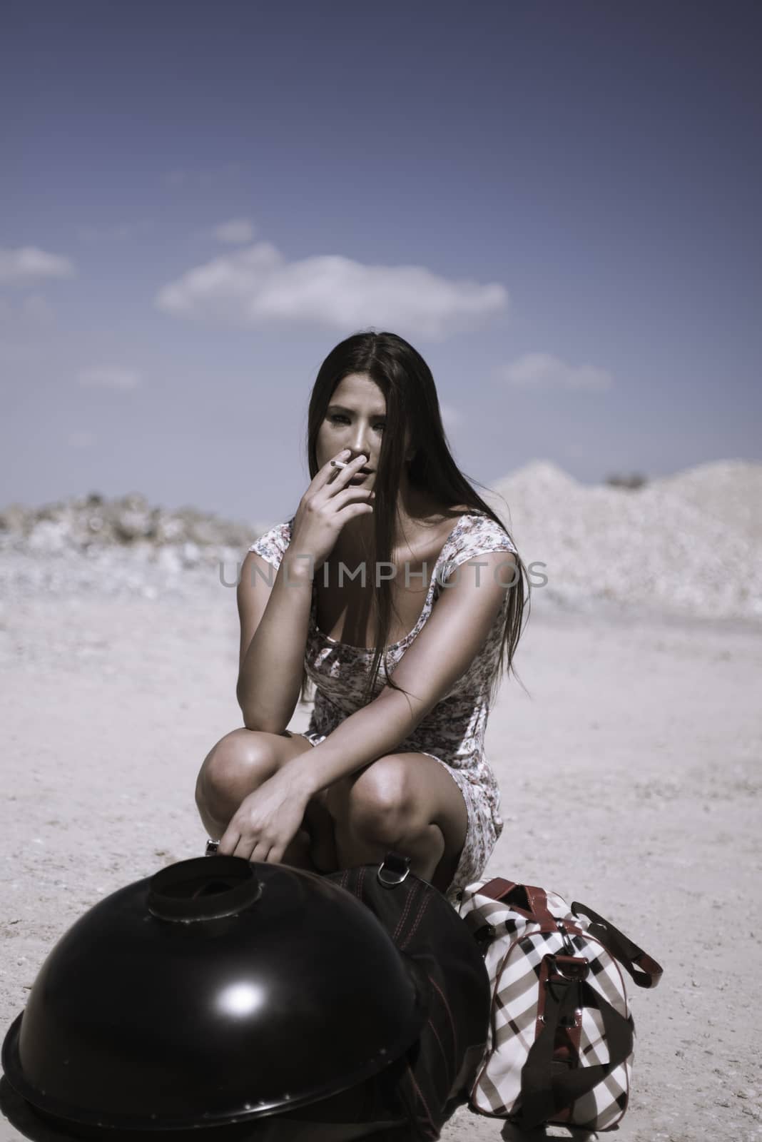 Lady in dress hitchhiking on a sunny day