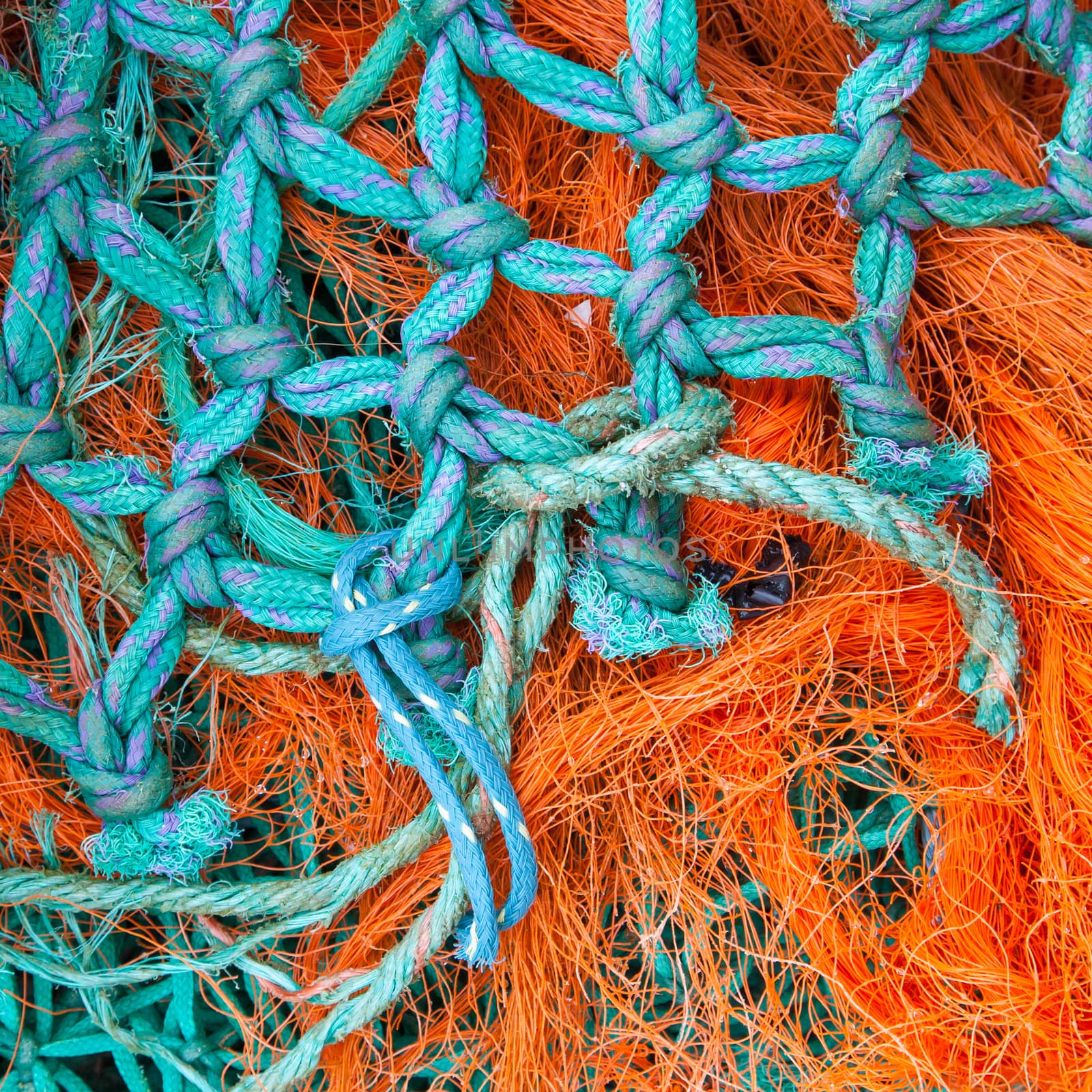 Abstract background with a pile of fishing nets by michaklootwijk