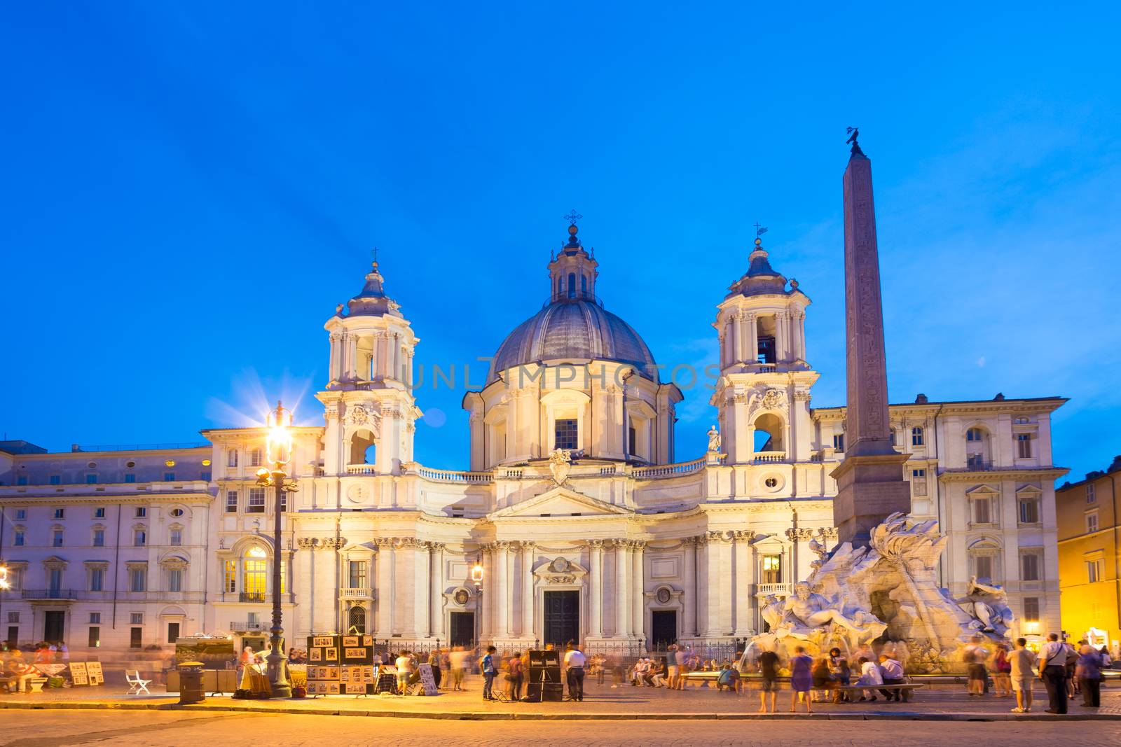 Fountain of the four Rivers and SantAgnese in Agone on Navona square in Rome, Italy, Europe shot at dusk.