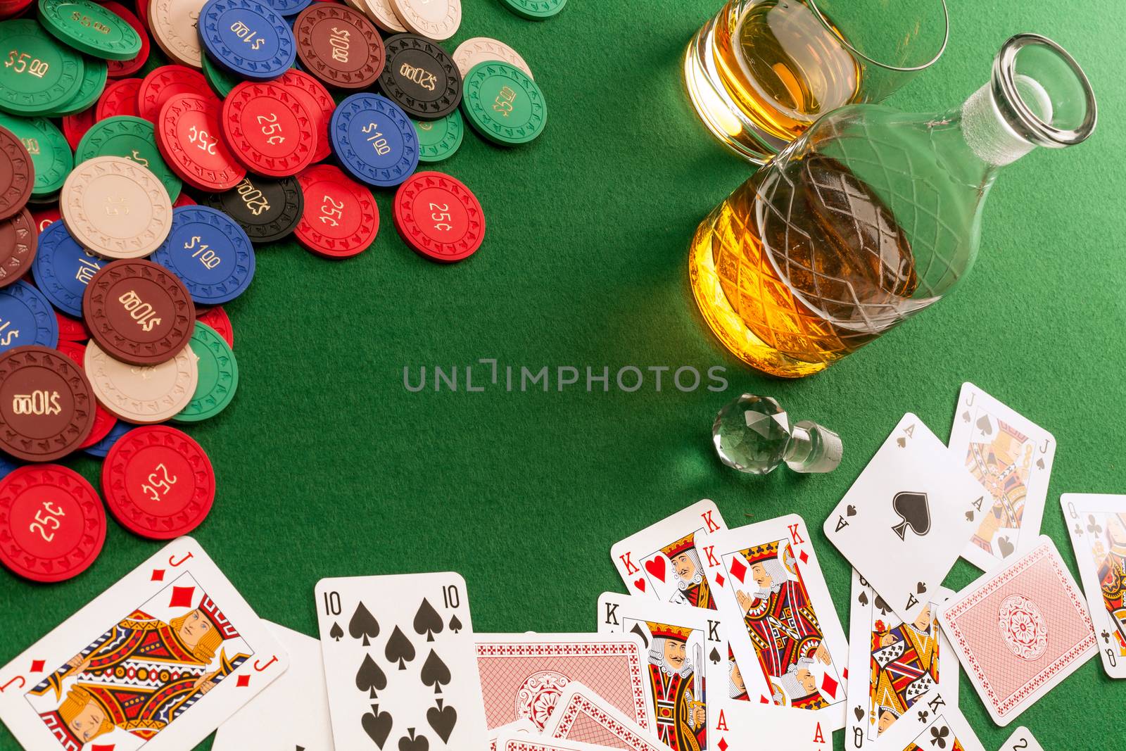 Gambling table with cards and poker chips by sumners