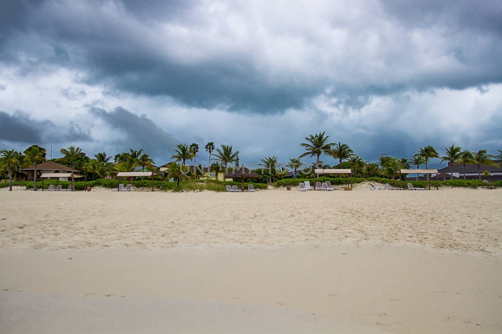 dark storm clouds over a beach resort
