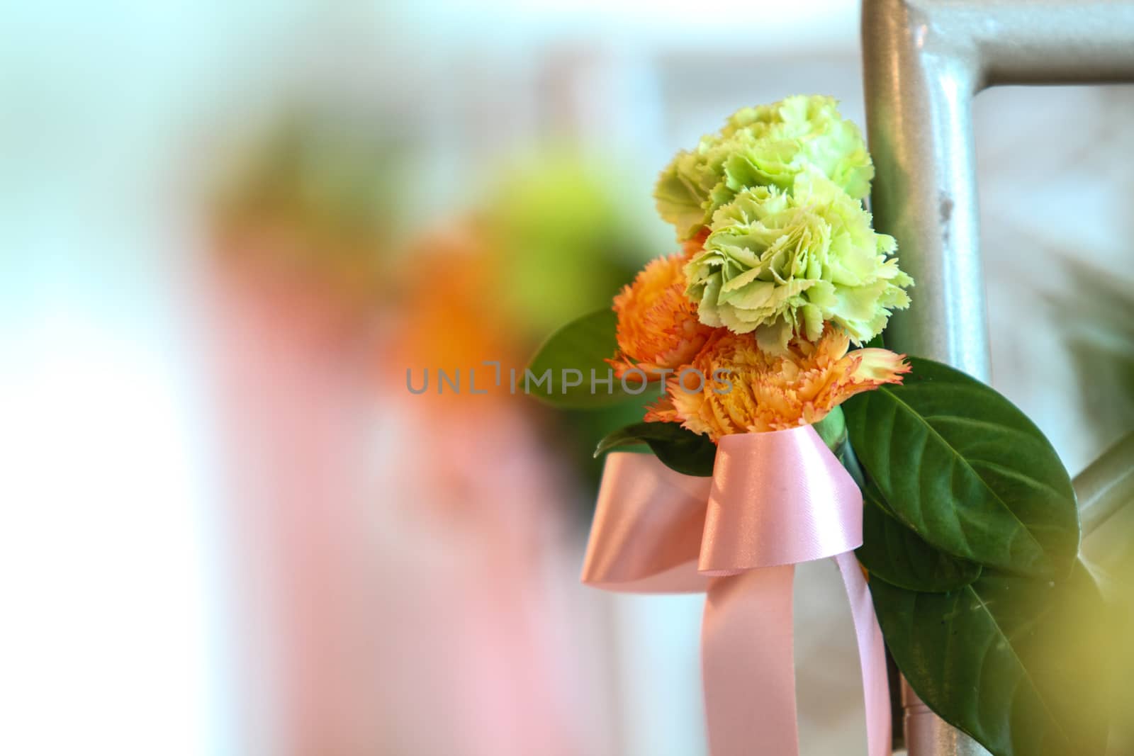 Closeup bouquet carnation flowers and pink ribbon