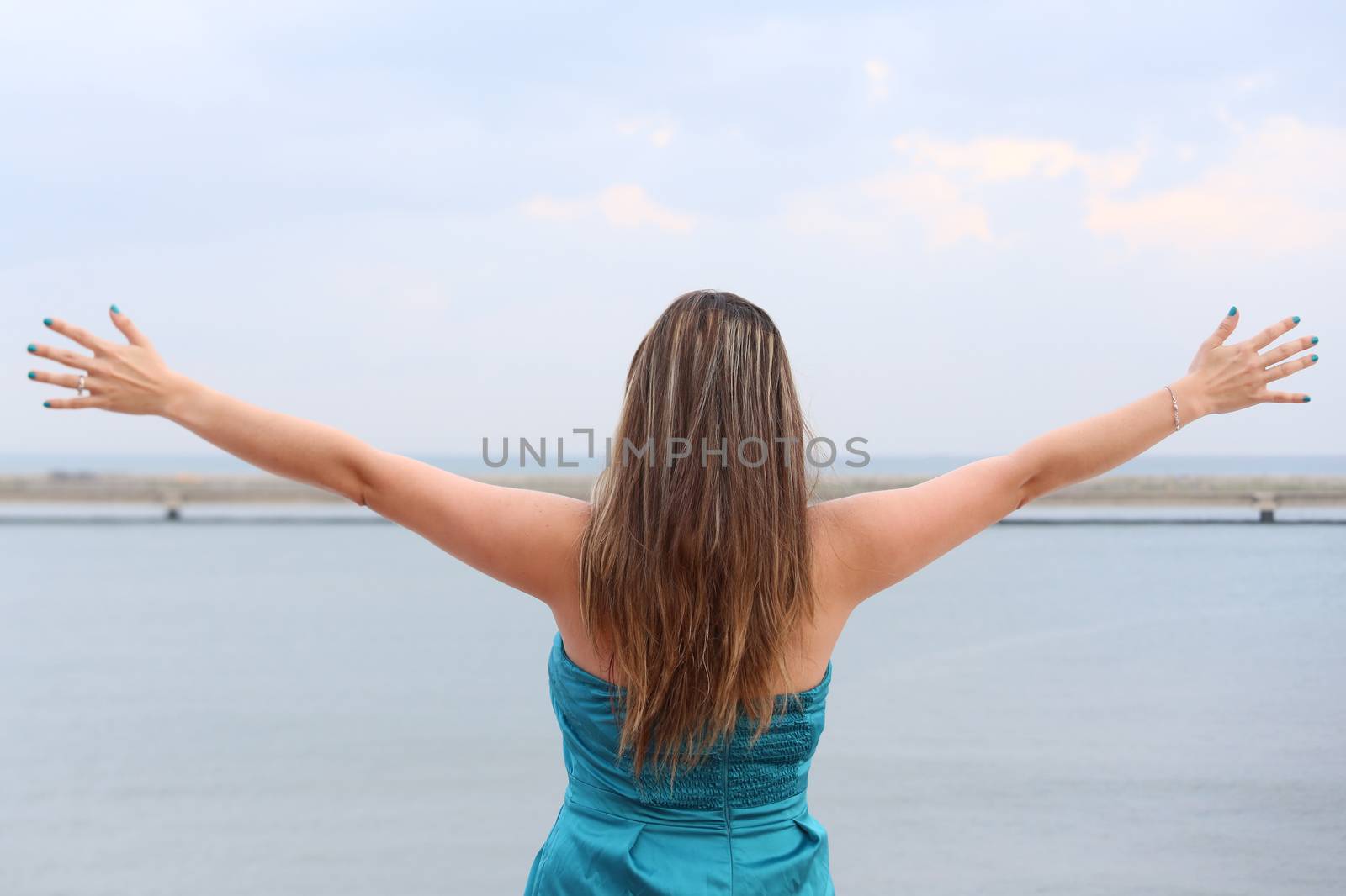 woman standing back with open arms