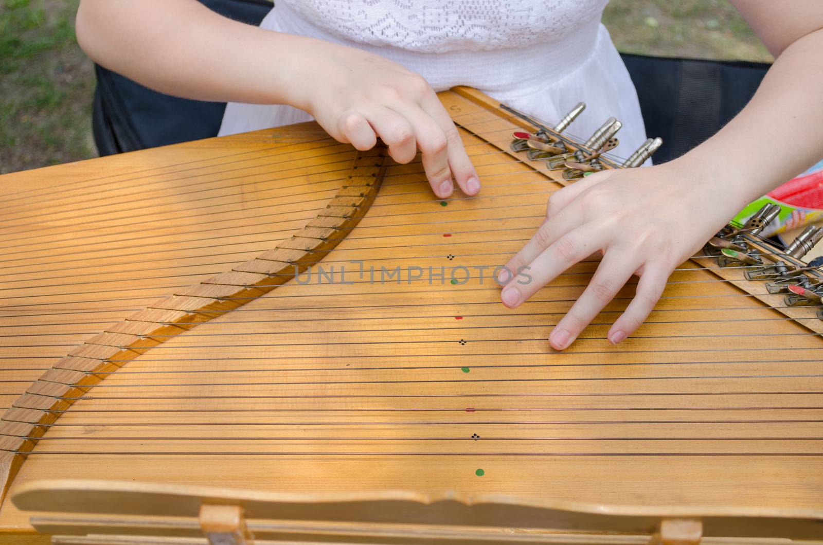 ancient stringed baltic psaltery and girls hands by sauletas