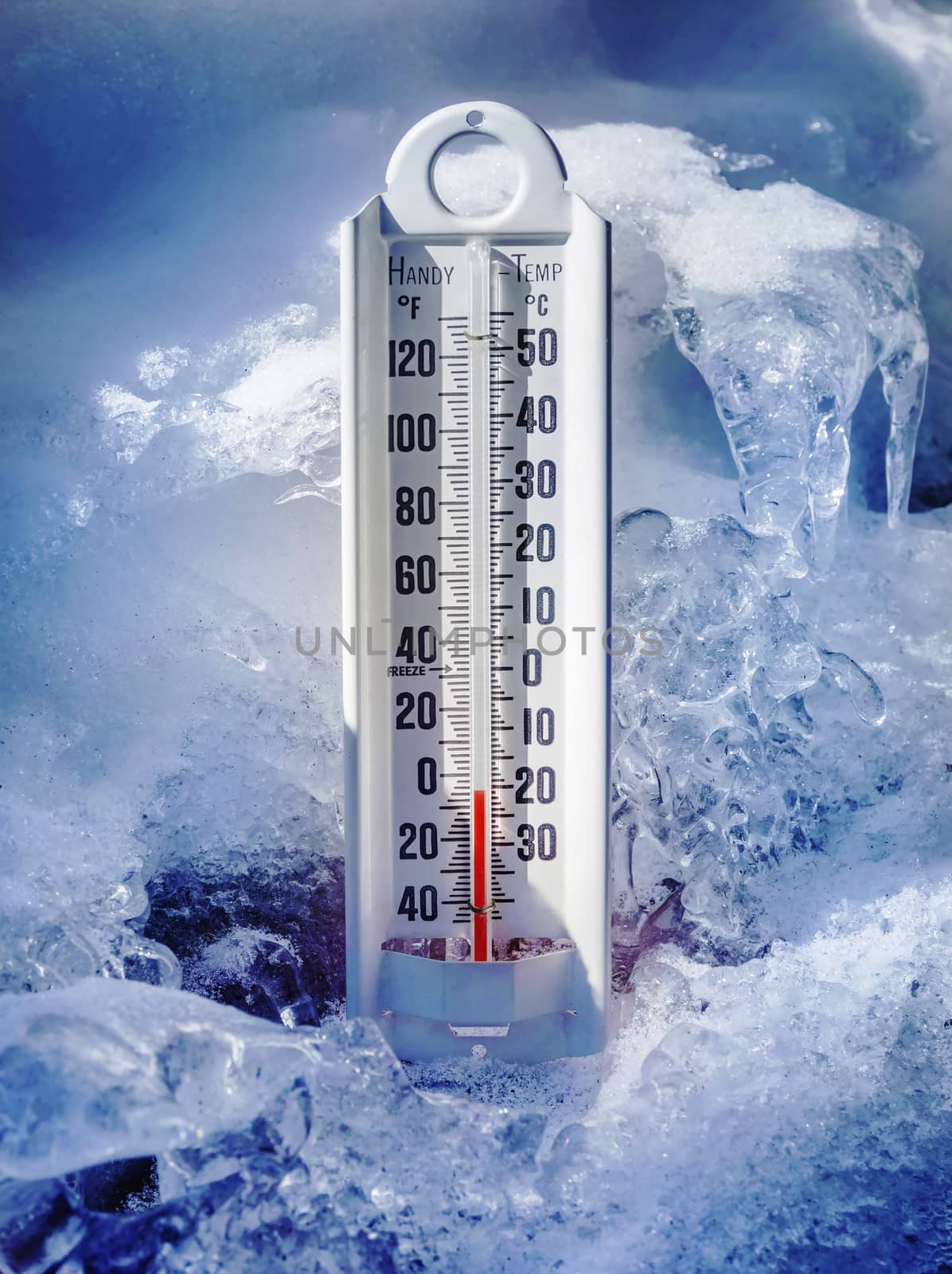 Ice cold thermometer in ice and snow to illustrate global warming