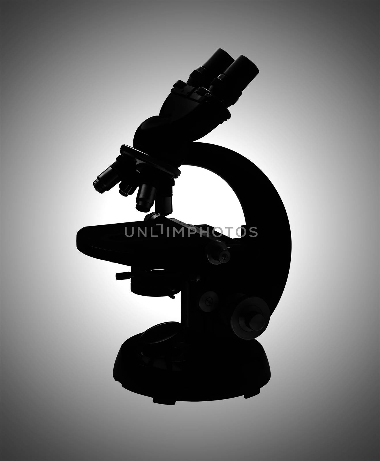 Microscope in silhouette on a graduated white to gray background, isolated