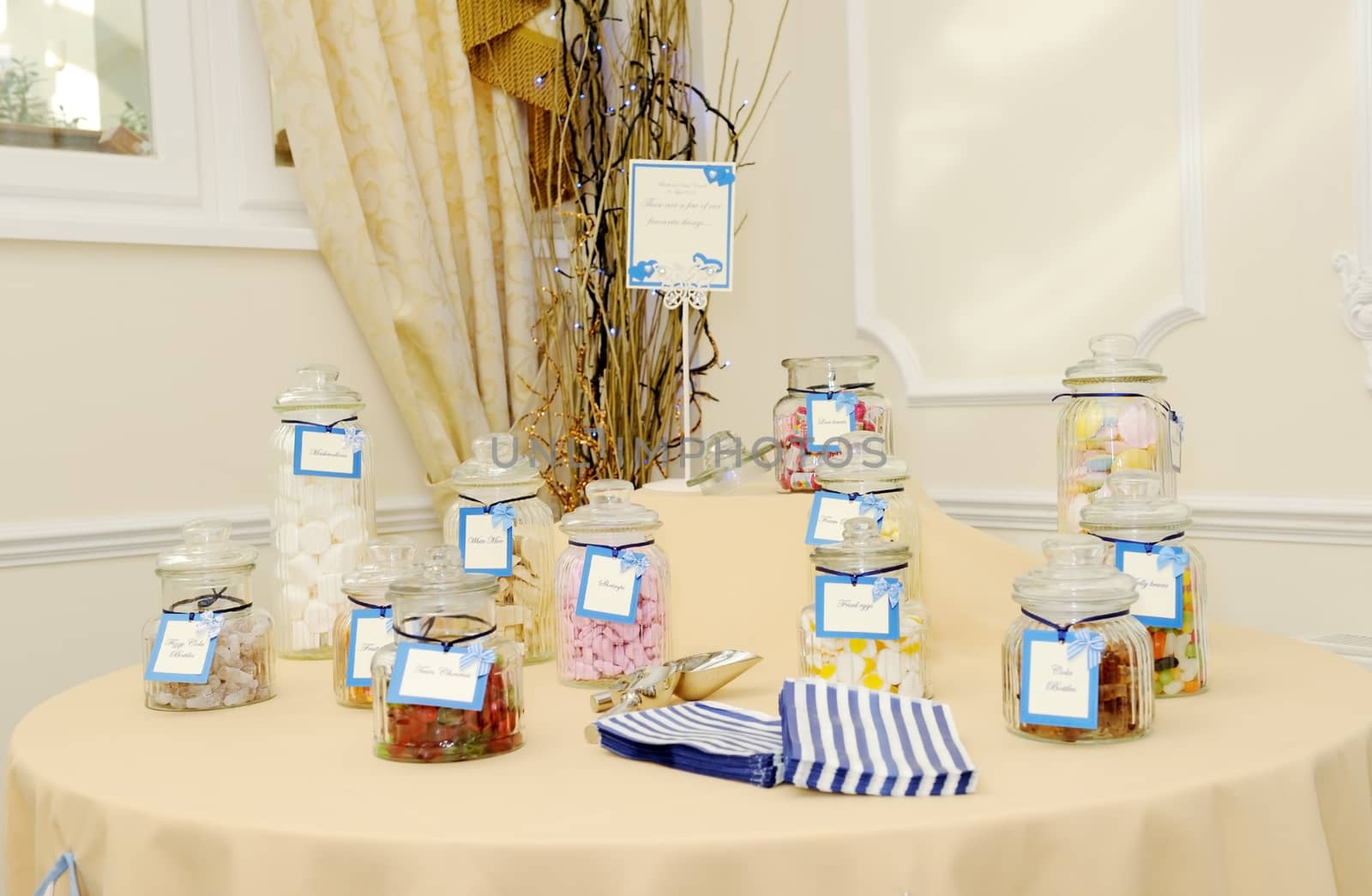 Decorated table at wedding reception with candy buffet