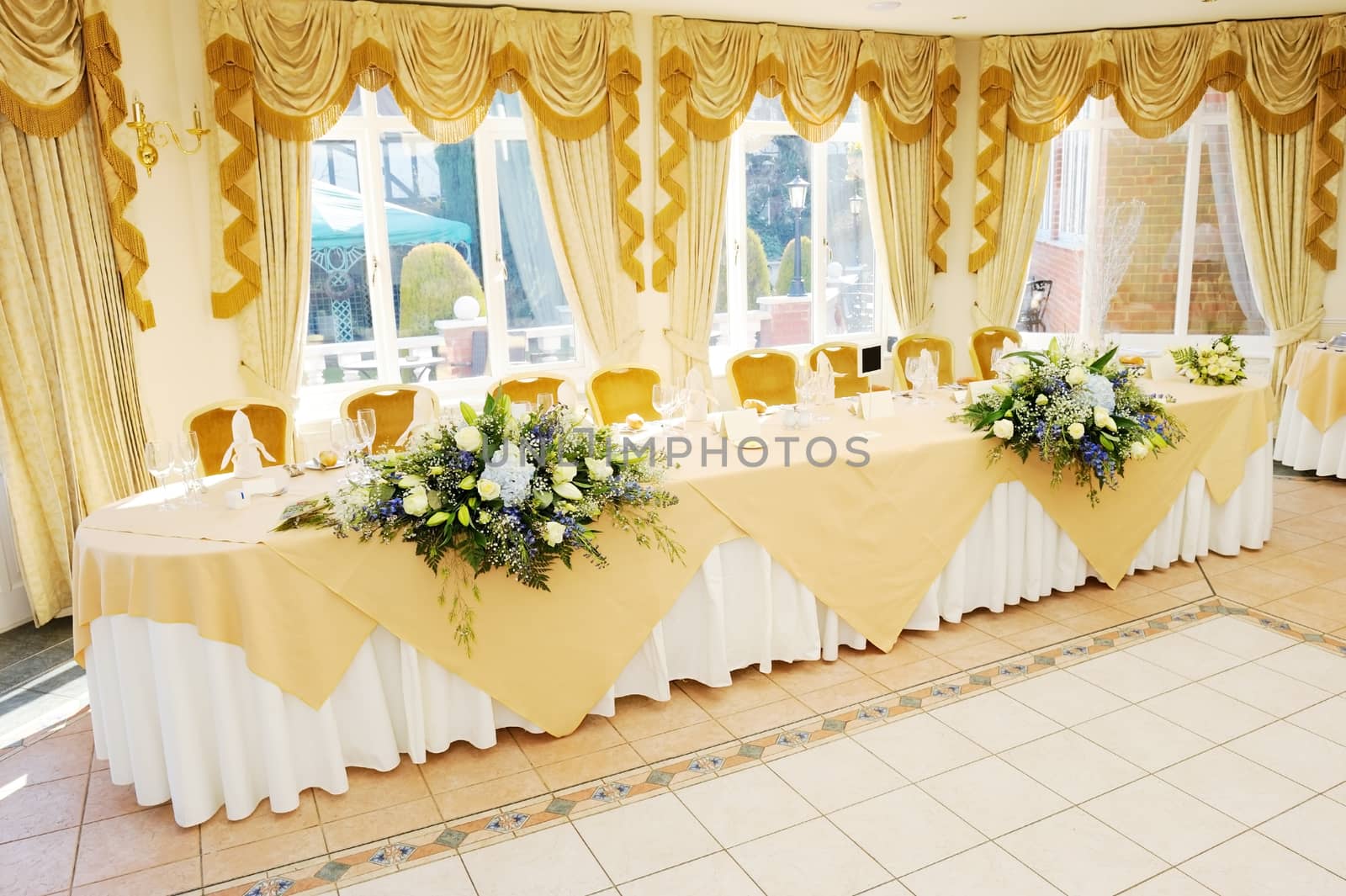 Decoration of flowers on head table at wedding reception