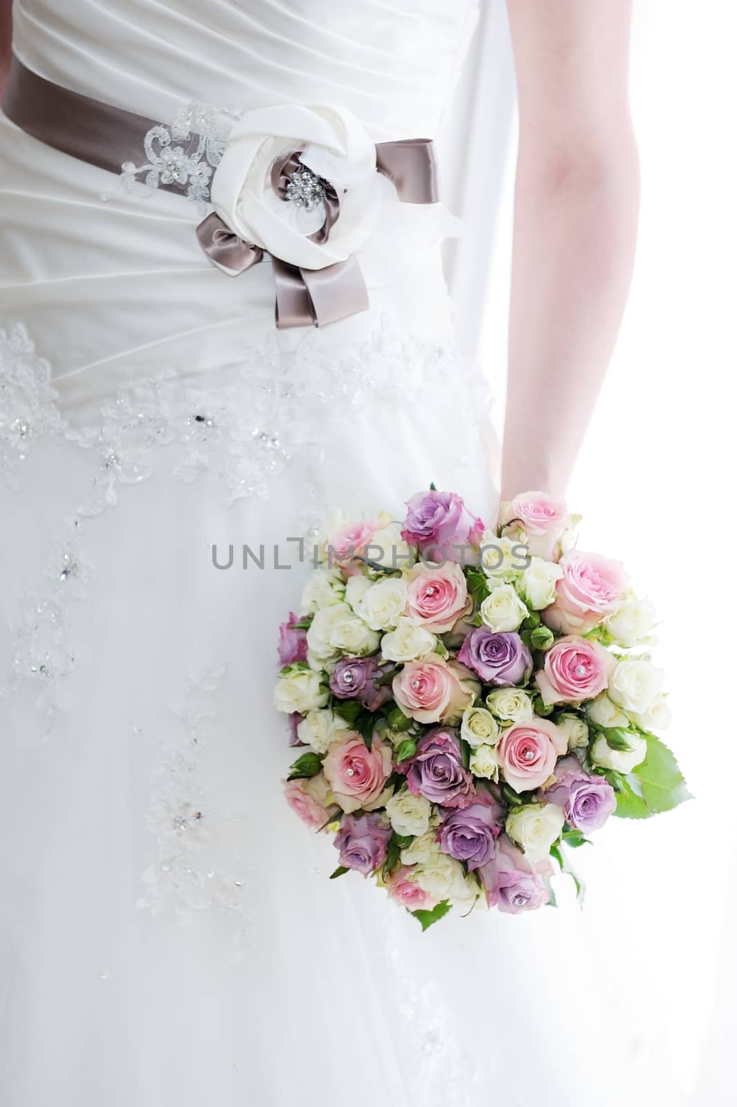 Brides bouquet and dress detail on wedding day