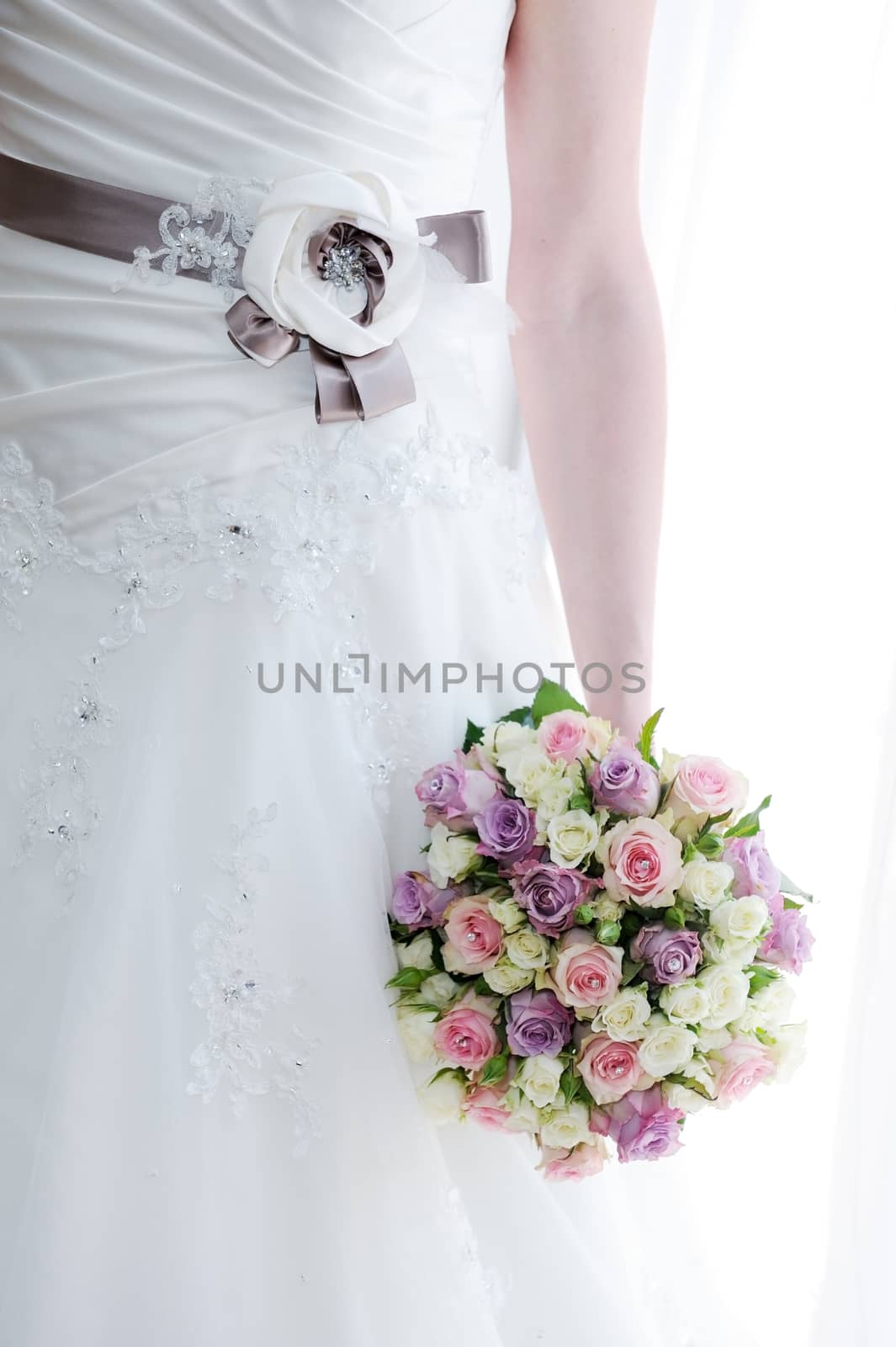 Brides dress detail and closeup of bouquet on wedding day
