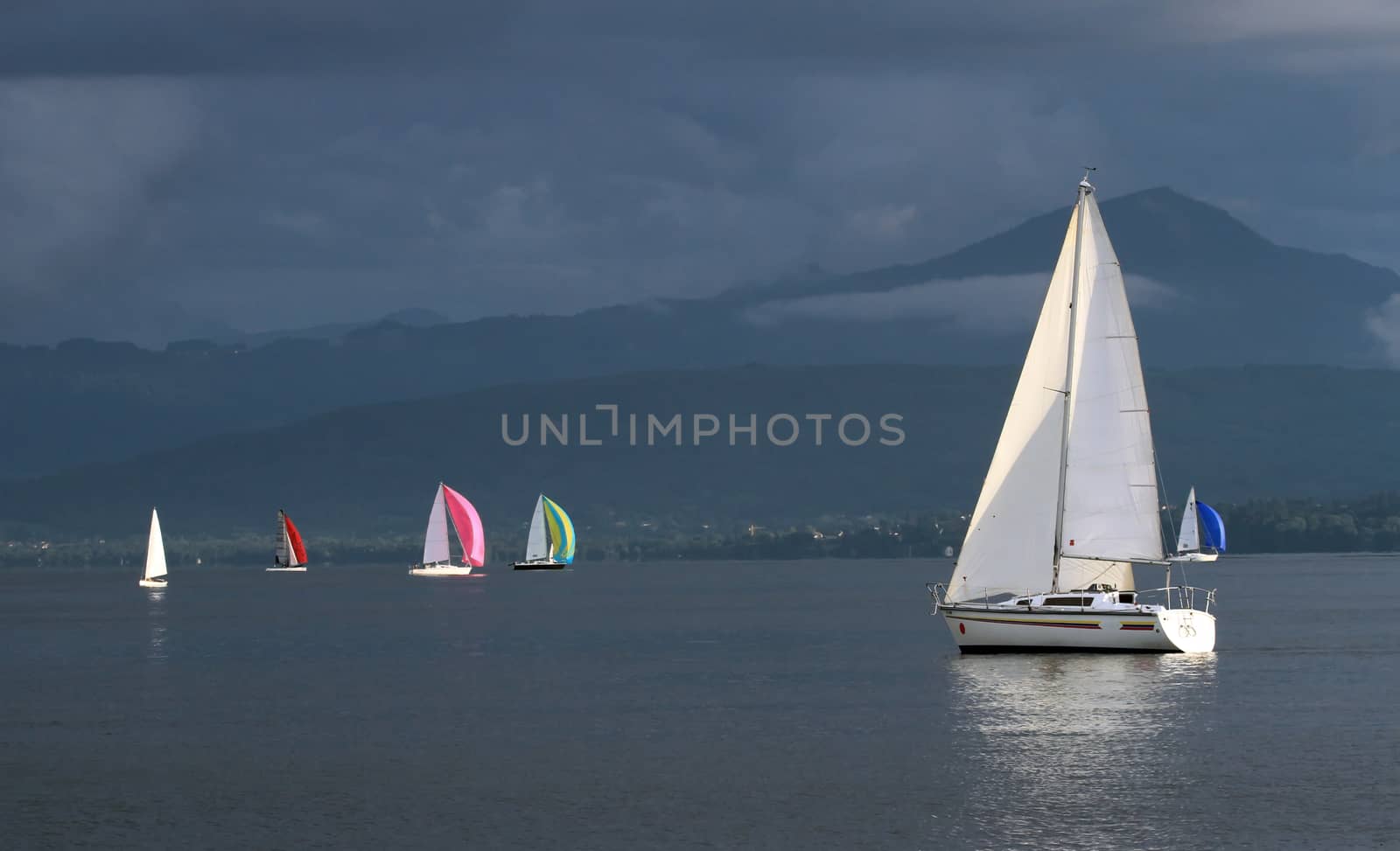 Colorful sailing boats by stormy weather, Geneva lake, Switzerland
