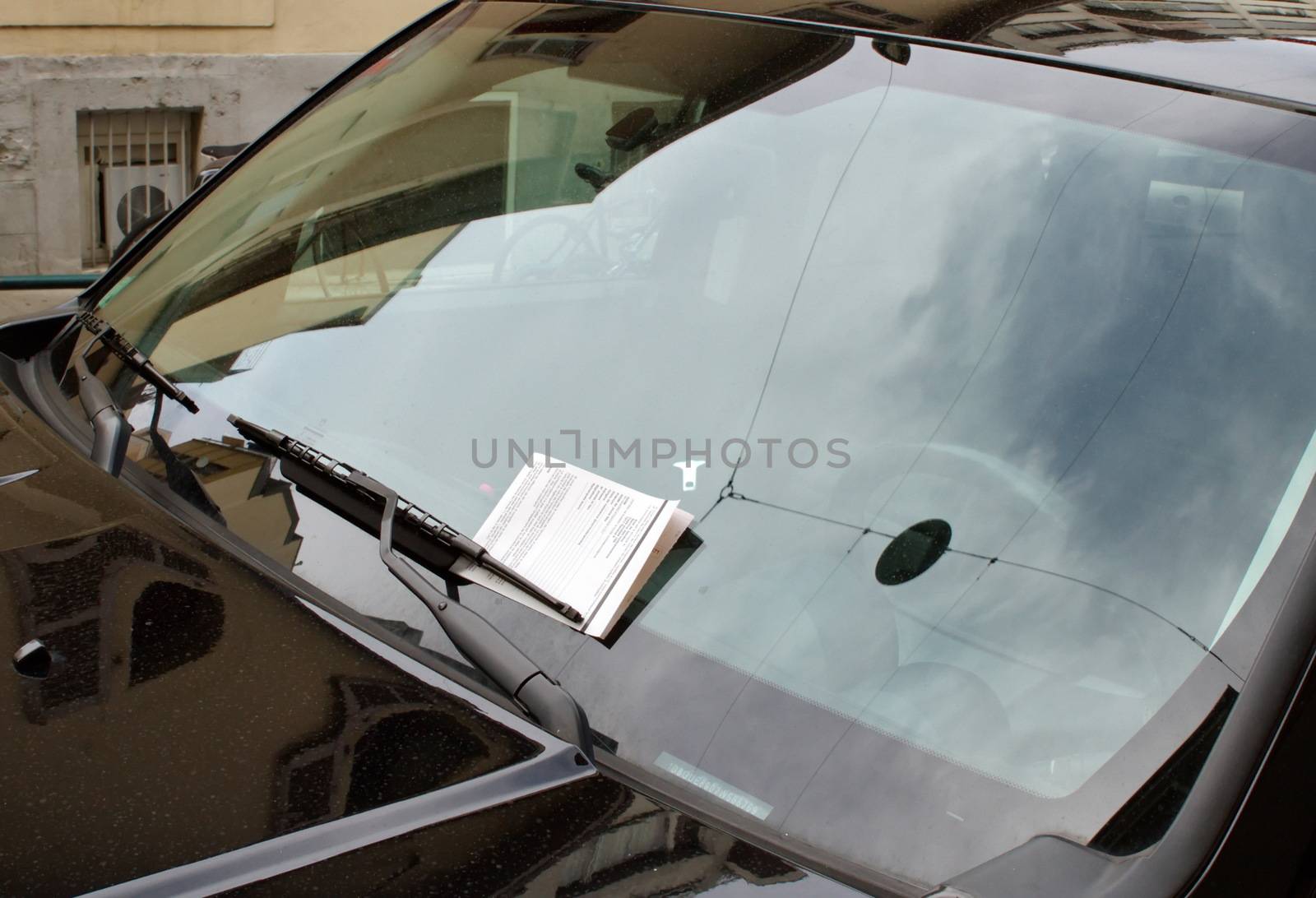 Swiss parking ticket on motor car windscreen or windshield