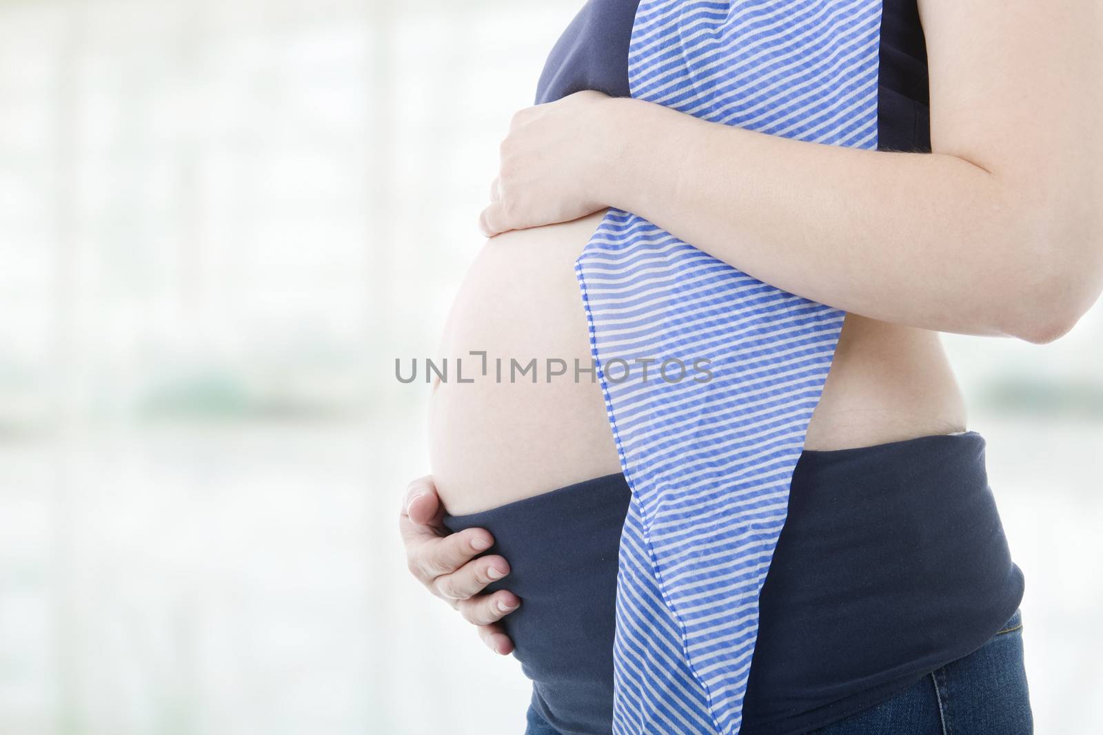 Closeup of pregnant woman at white background