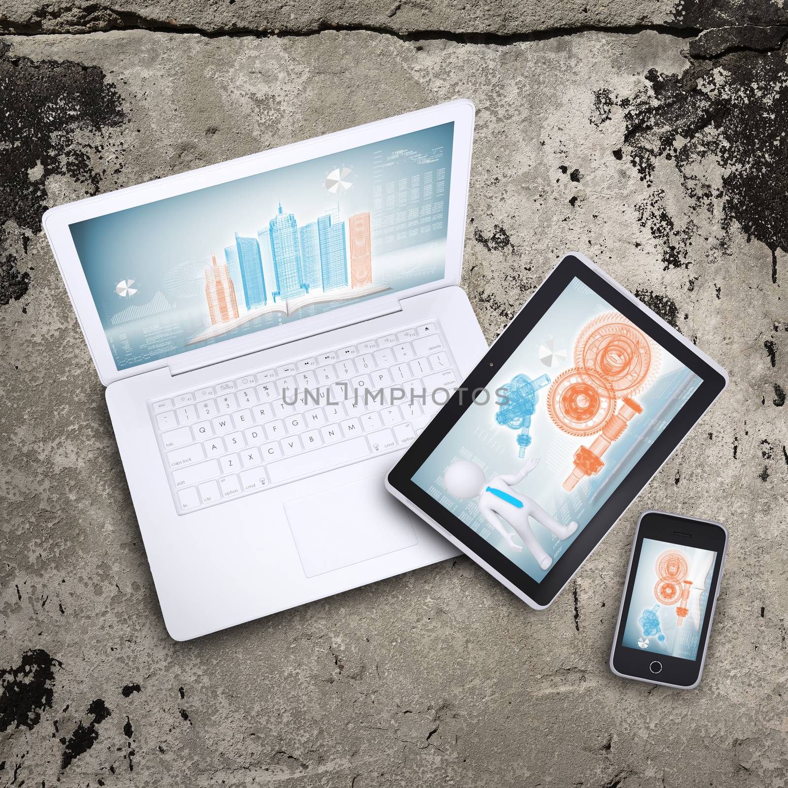 Laptop, tablet pc and smart phone on old concrete surface. Computer technology concept