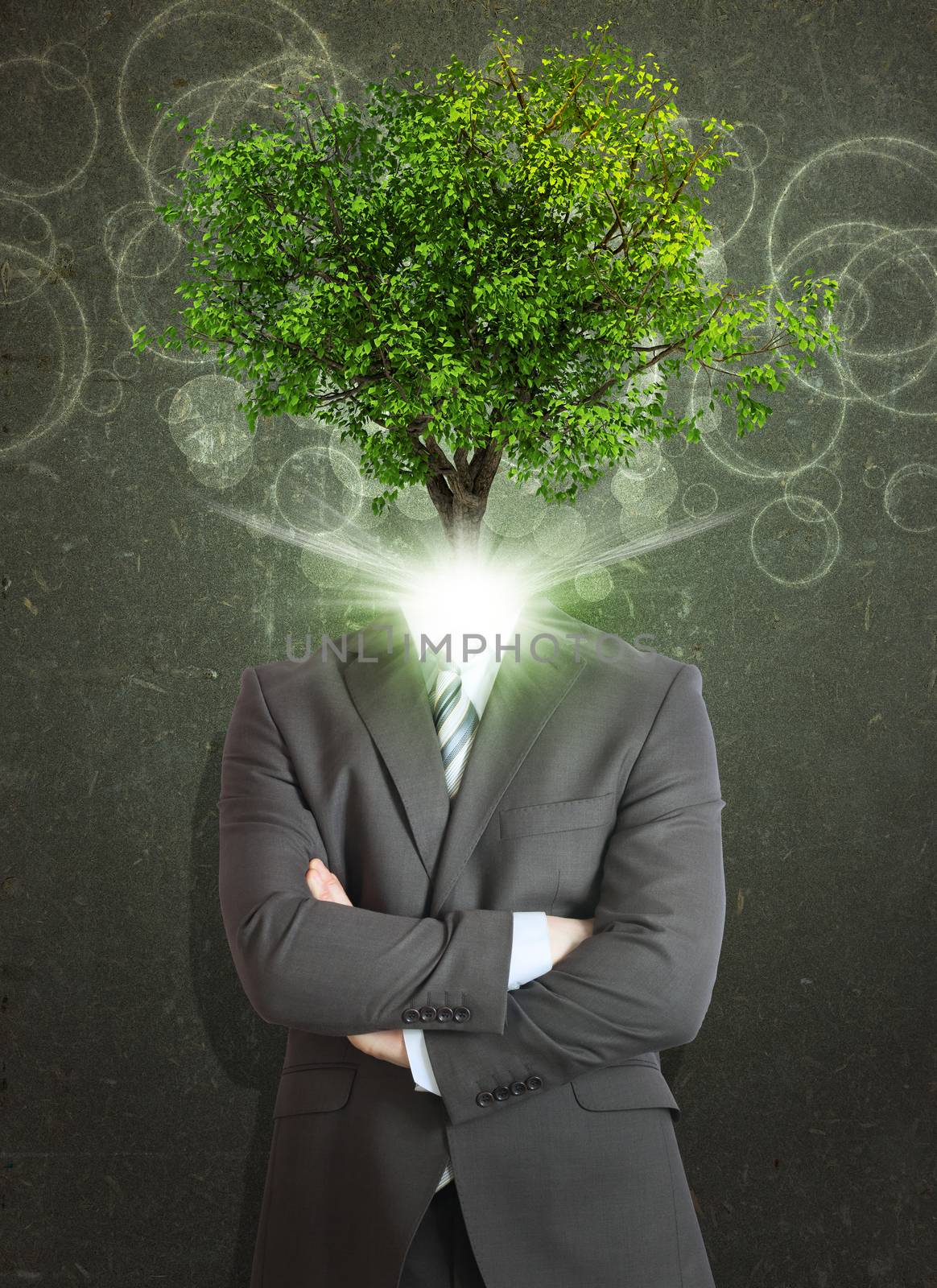 Businessman stand with green tree and bright light instead his head. Eco concept