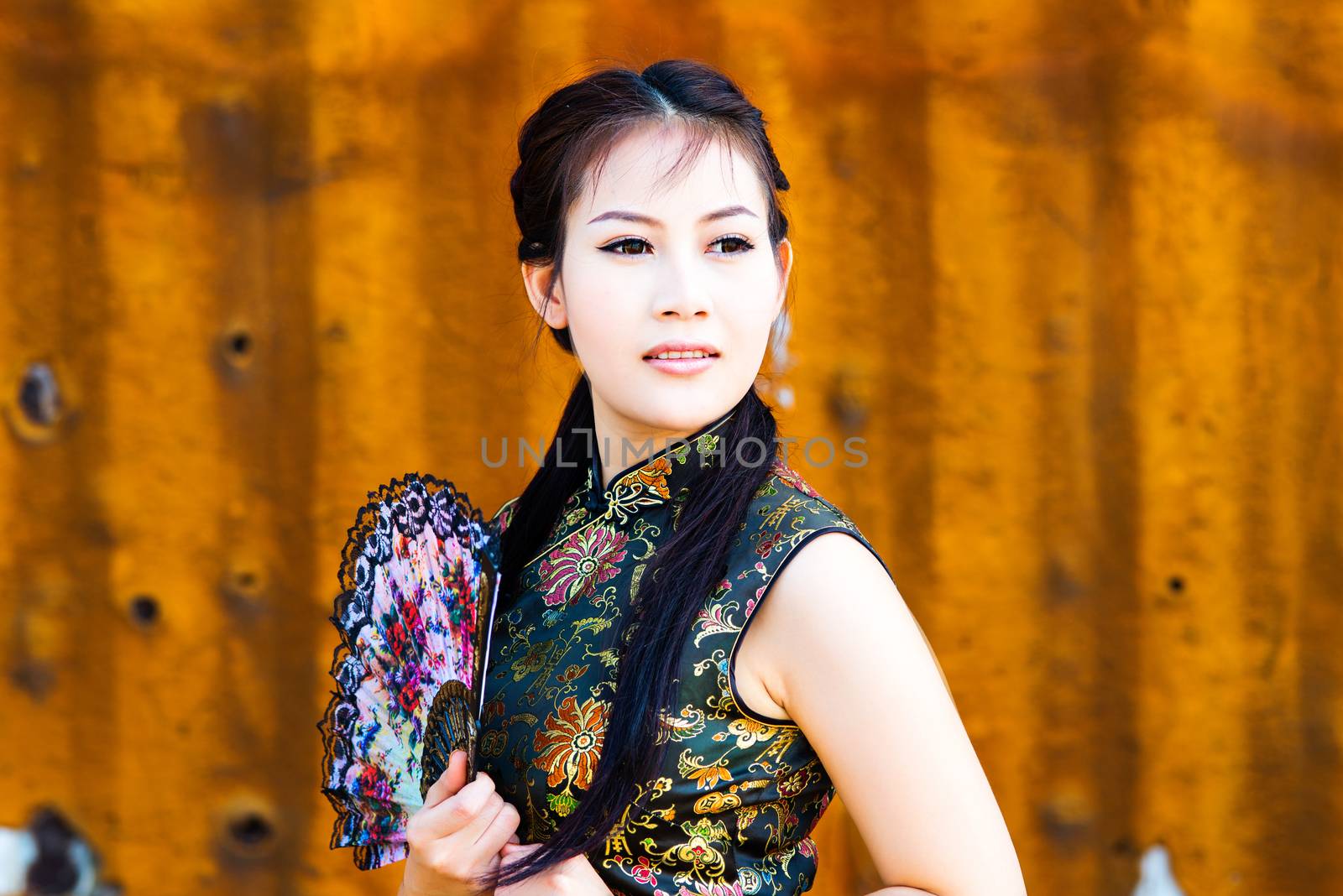Chinese girl in traditional Chinese cheongsam blessing
