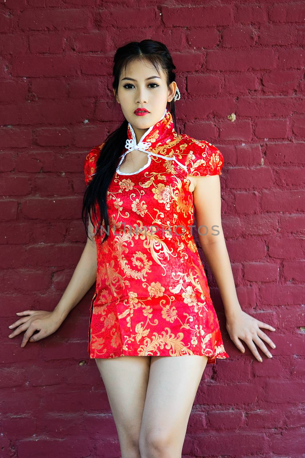 Chinese girl in traditional Chinese cheongsam blessing