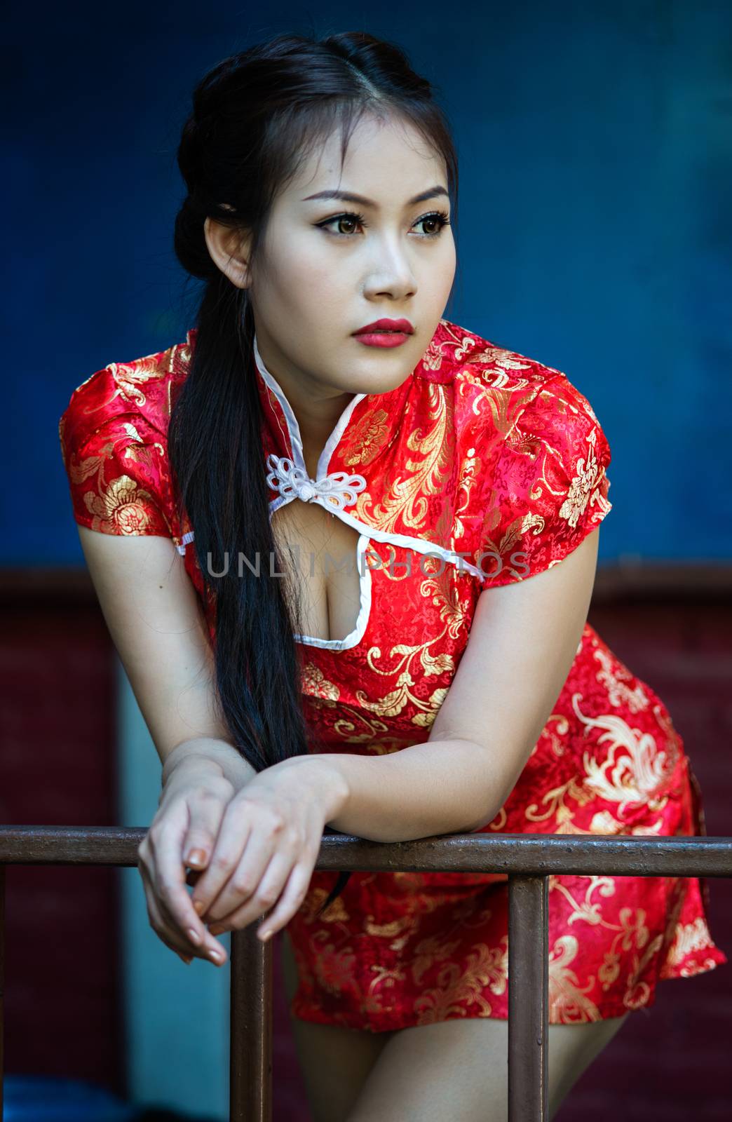 Chinese girl in traditional Chinese cheongsam blessing