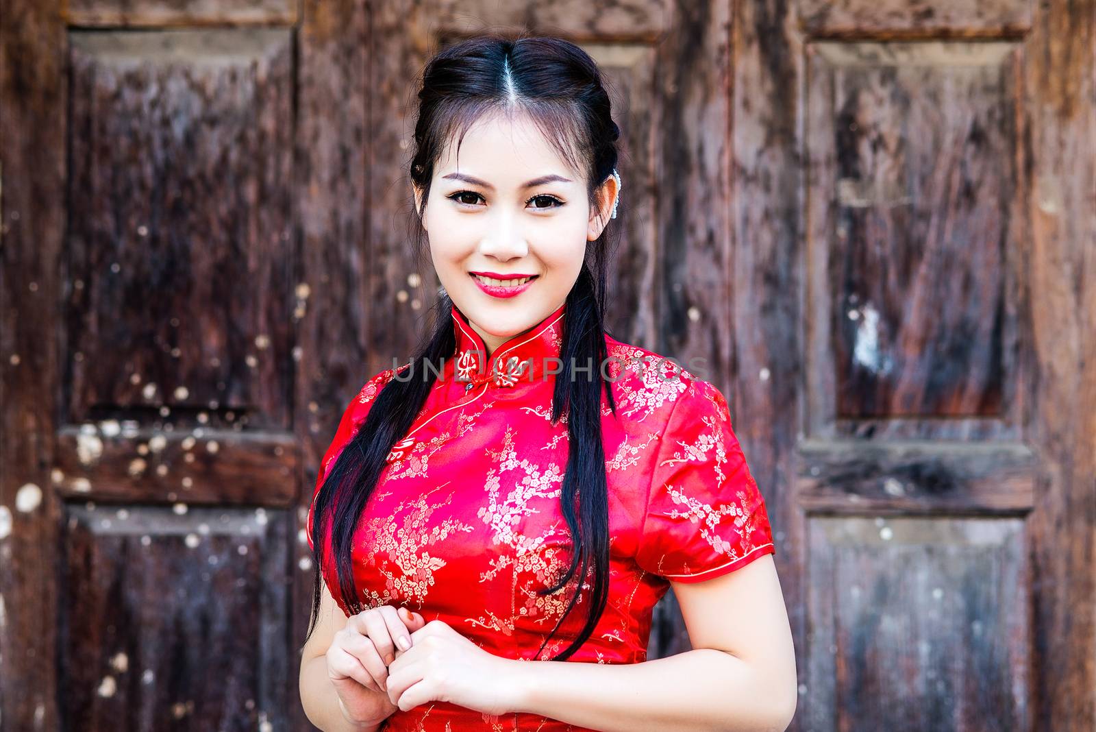 Chinese girl in traditional Chinese cheongsam blessing