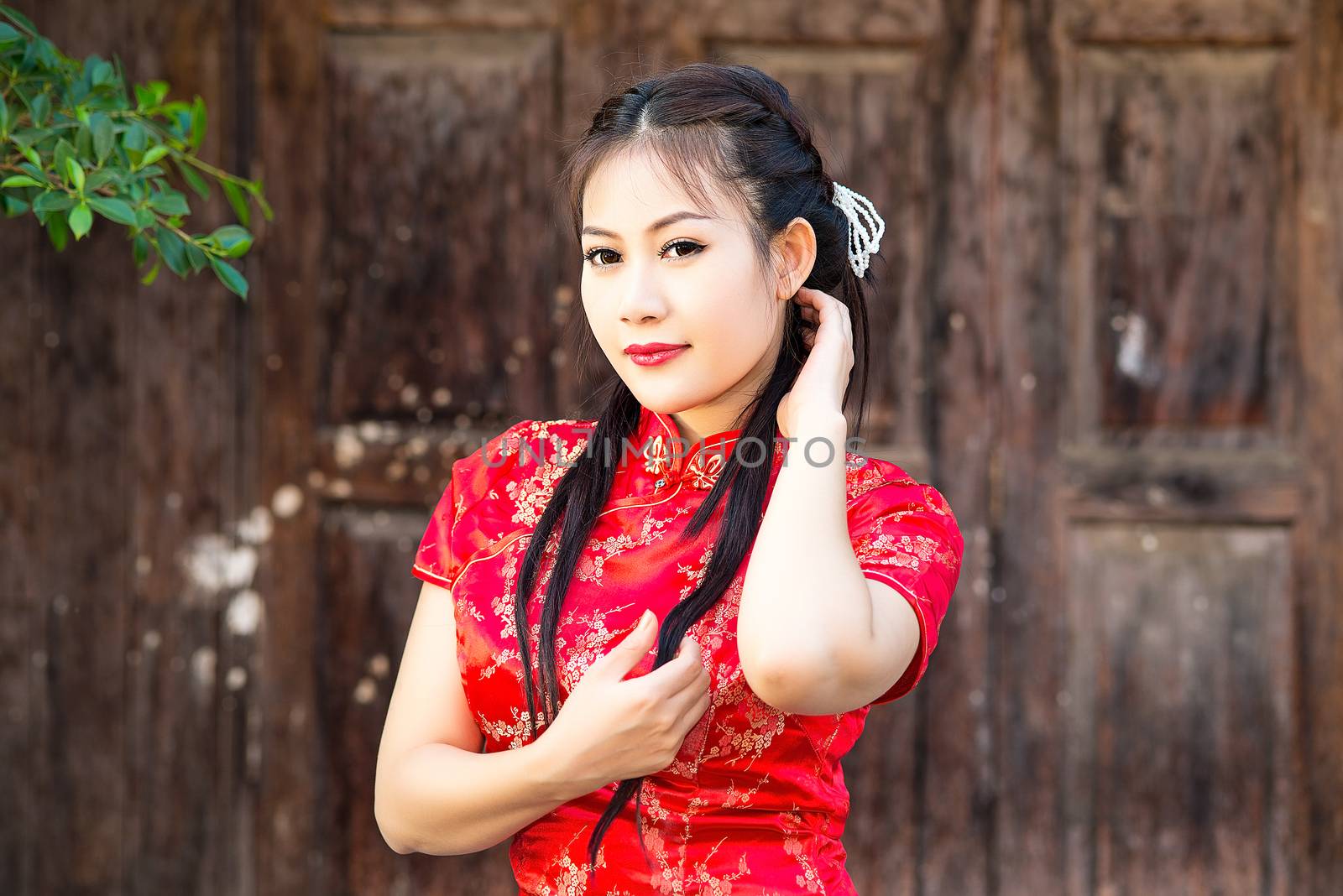 Chinese girl in traditional Chinese cheongsam blessing