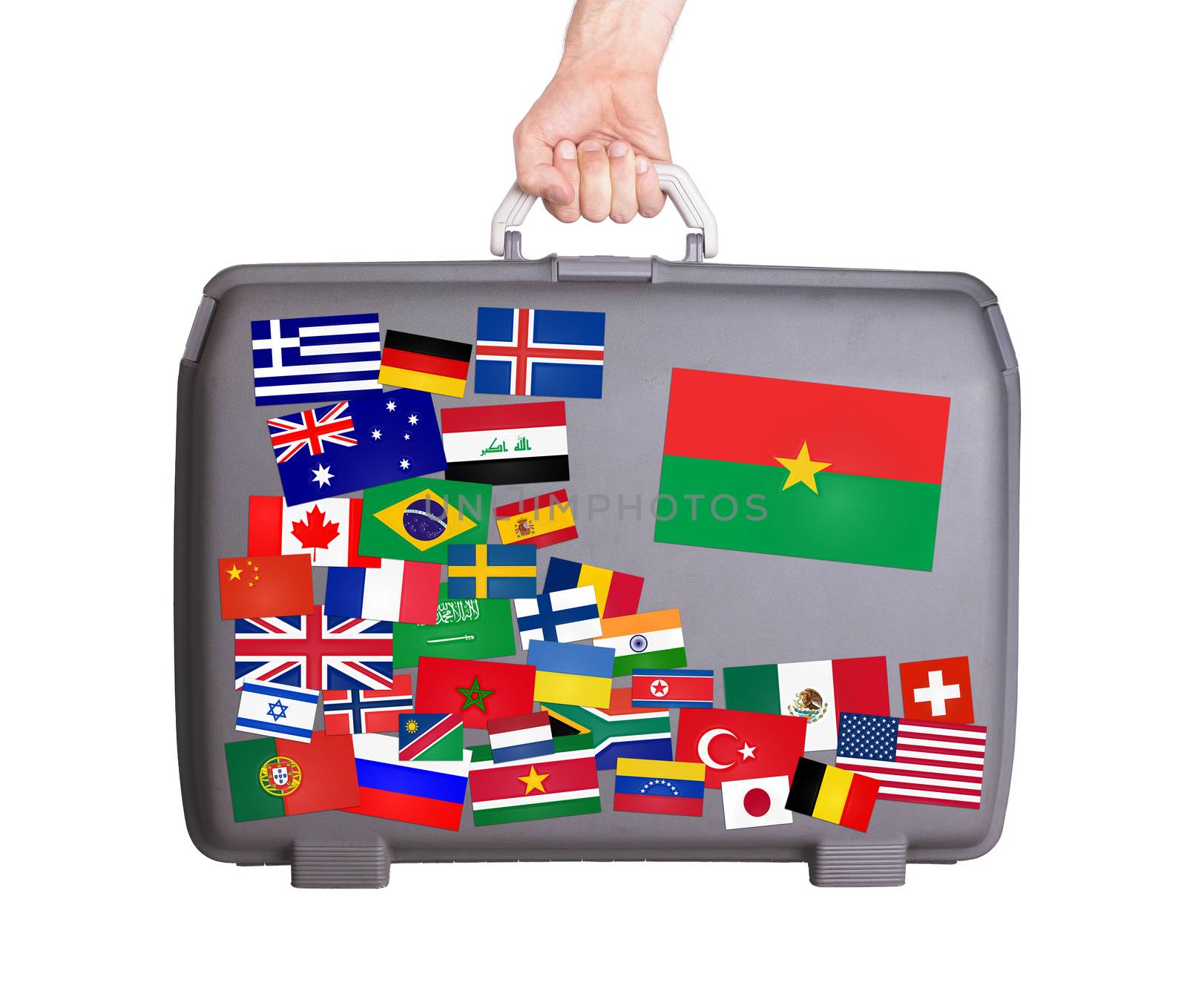 Used plastic suitcase with lots of small stickers, large sticker of Burkina Faso
