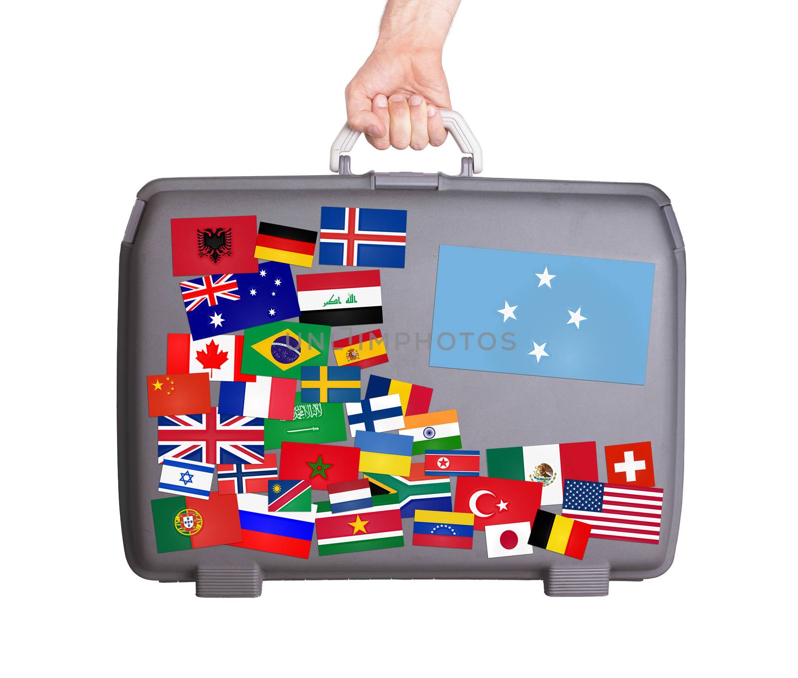 Used plastic suitcase with lots of small stickers, large sticker of Micronesia