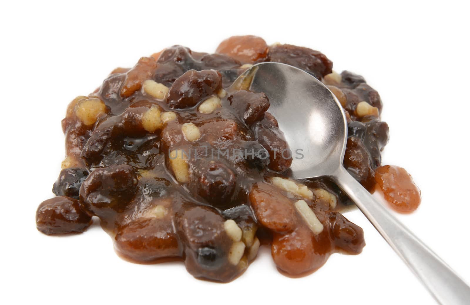 Closeup of traditional mincemeat mixture of dried fruit, candied peel and suet, with a metal teaspoon, isolated on a white background