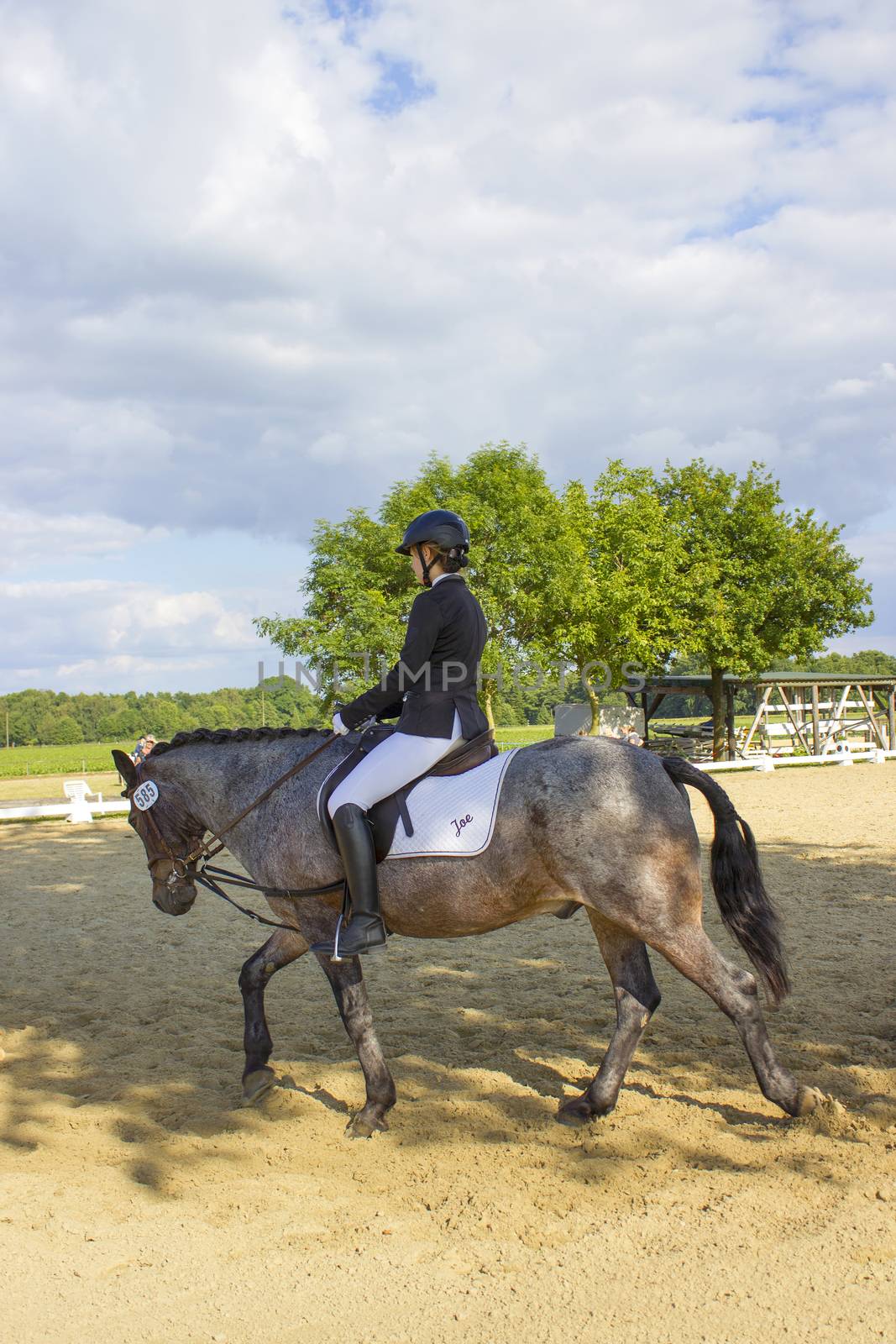 young girl riding a horse outdoors by miradrozdowski