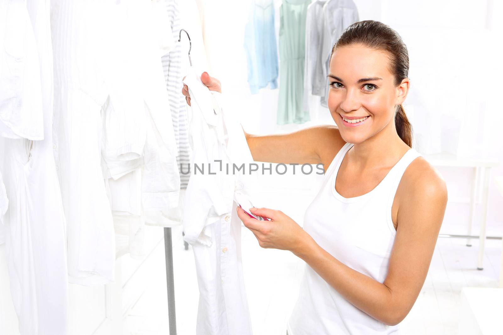 Woman shopping in a clothing boutique, by robert_przybysz