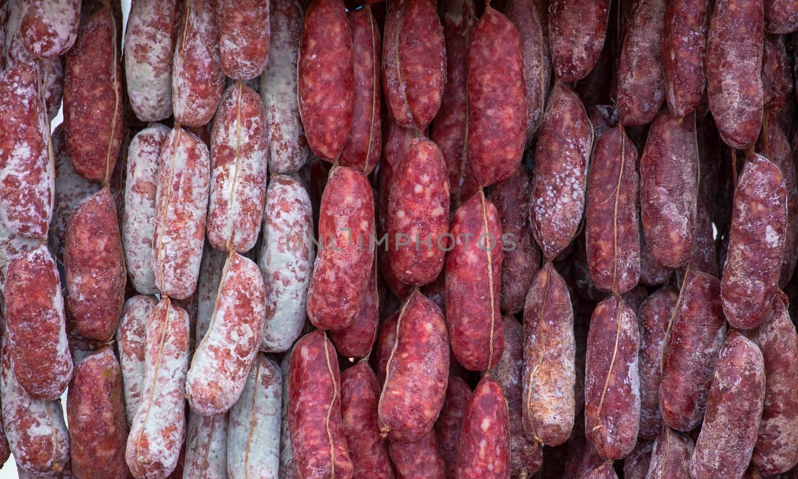 Close up of delicious Italian salami hanging on the rope
