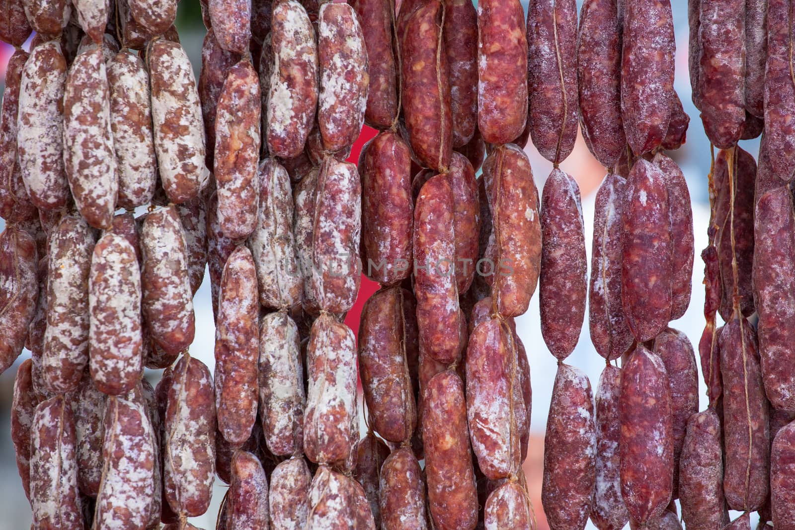Close up of delicious Italian salami hanging on the rope