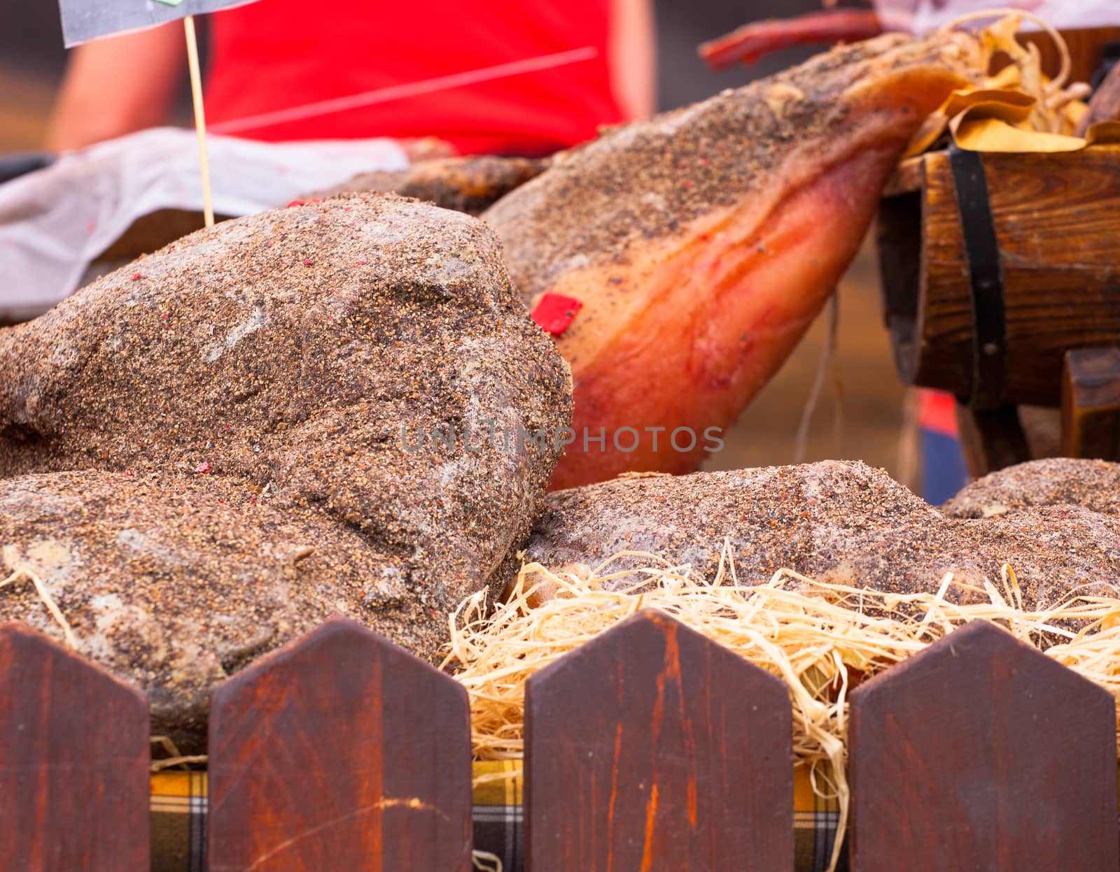 Close up of Italian raw ham covered by pepper