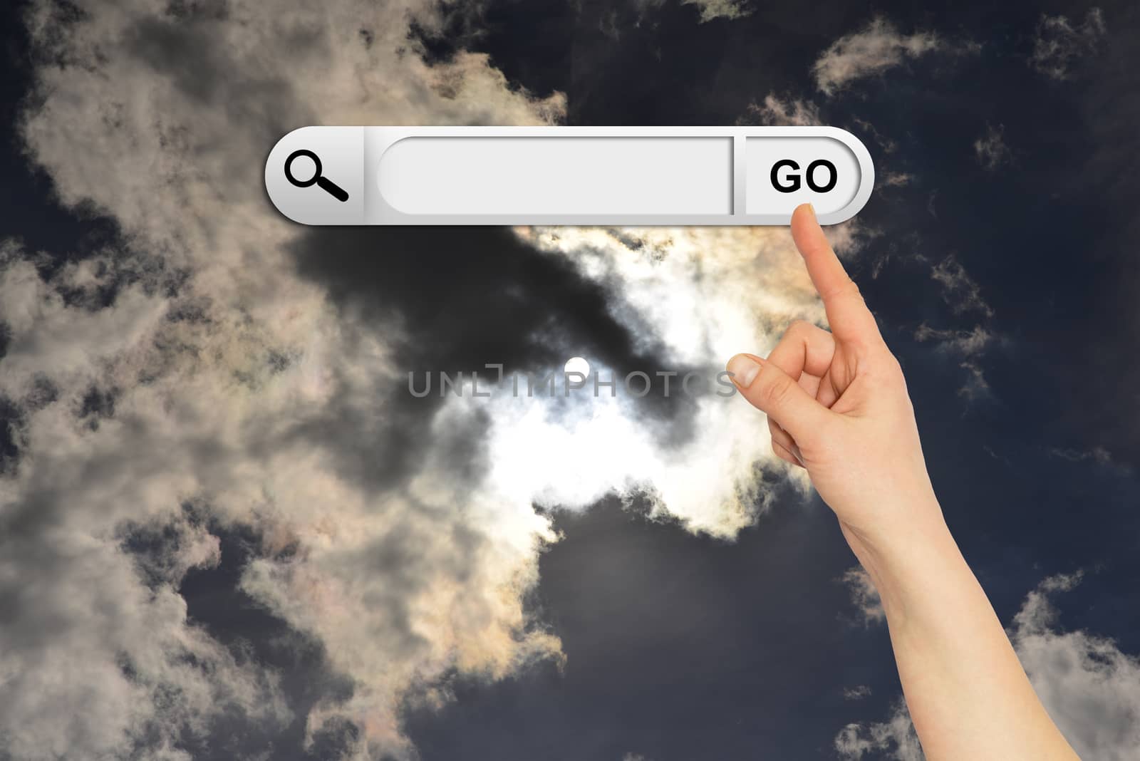 Human hand indicates the search bar in browser. Sunset or sunrise on background
