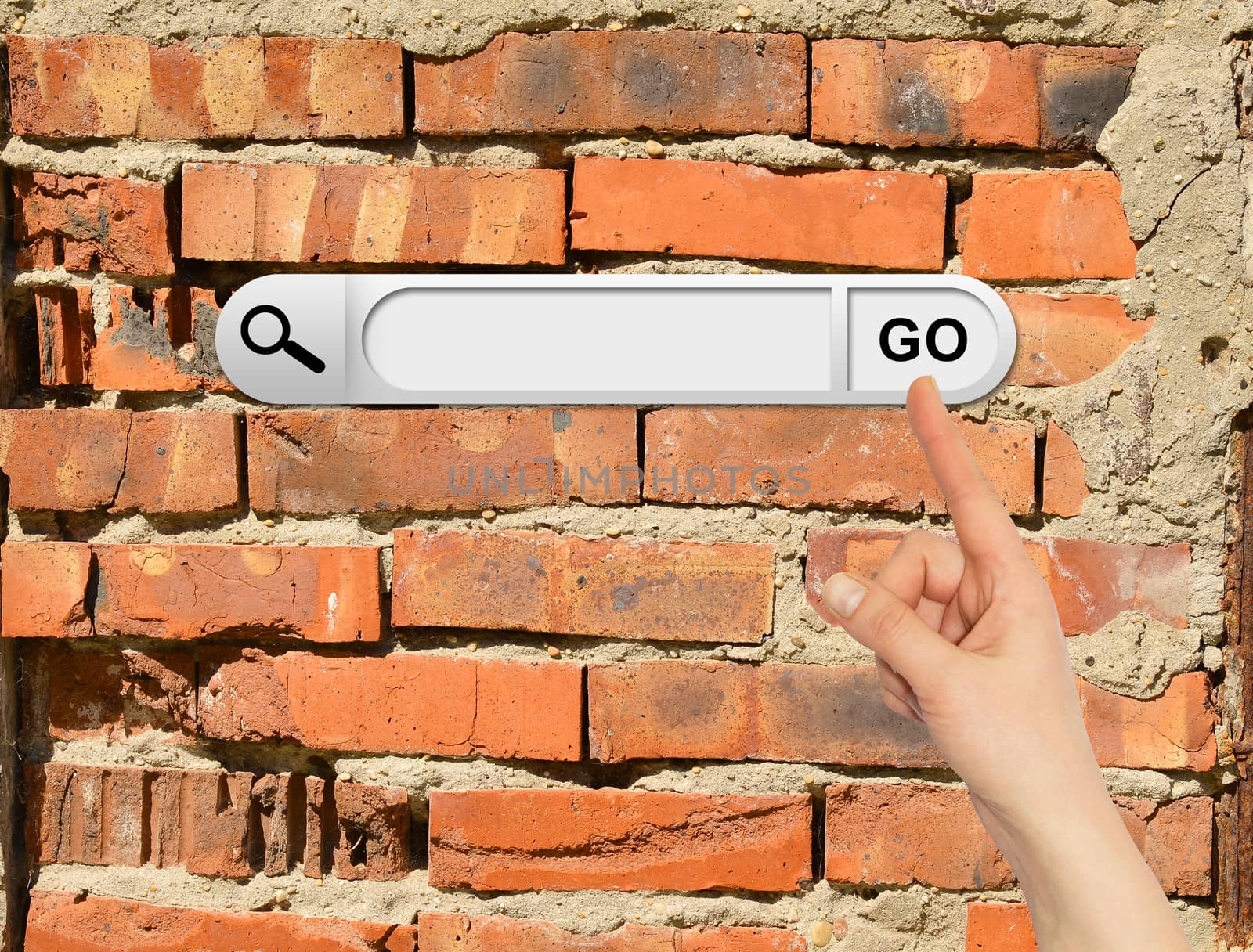 Human hand indicates the search bar in browser. Cracked bricks wall on background