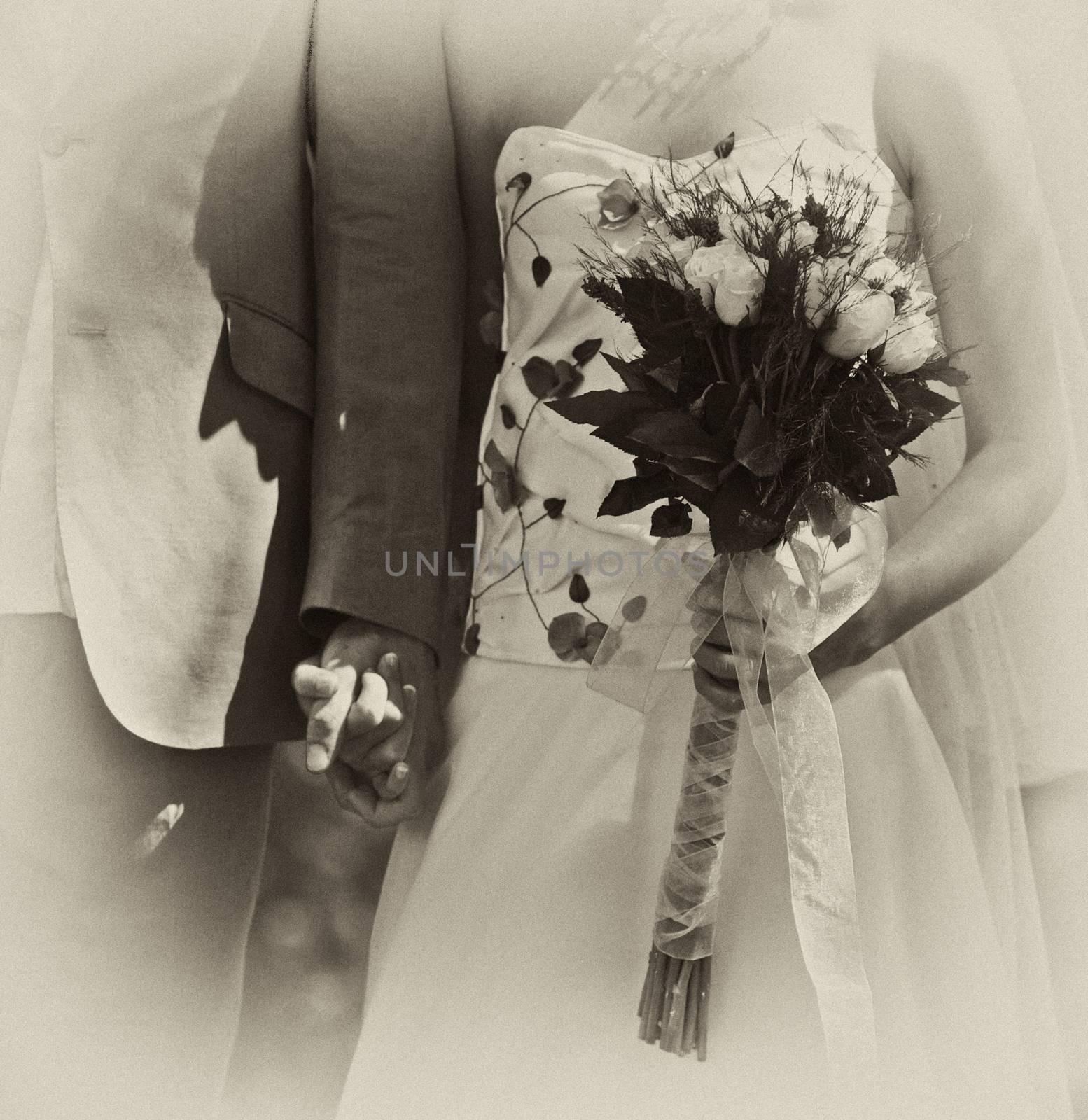 Wedding couple standing with bouquet