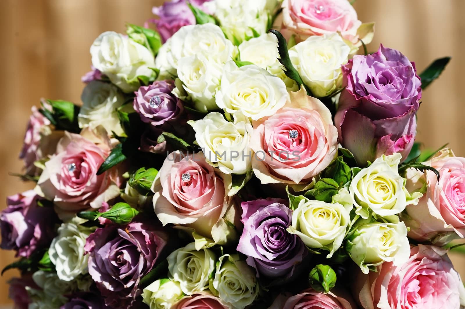 Brides bunch of colorful flowers are pink and purple roses