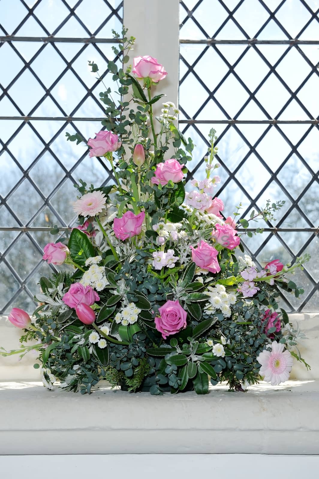 Flower arrangement on wedding day in church with pink roses