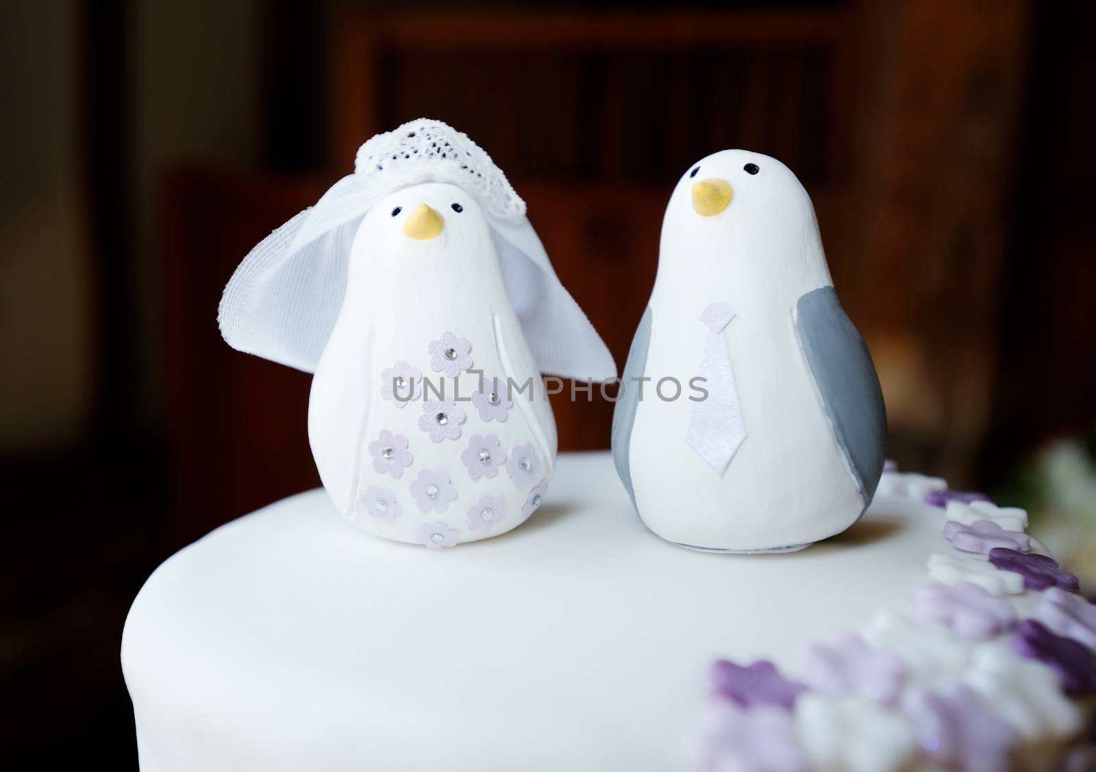 Wedding cake topper closeup detail of bride and groom penguins