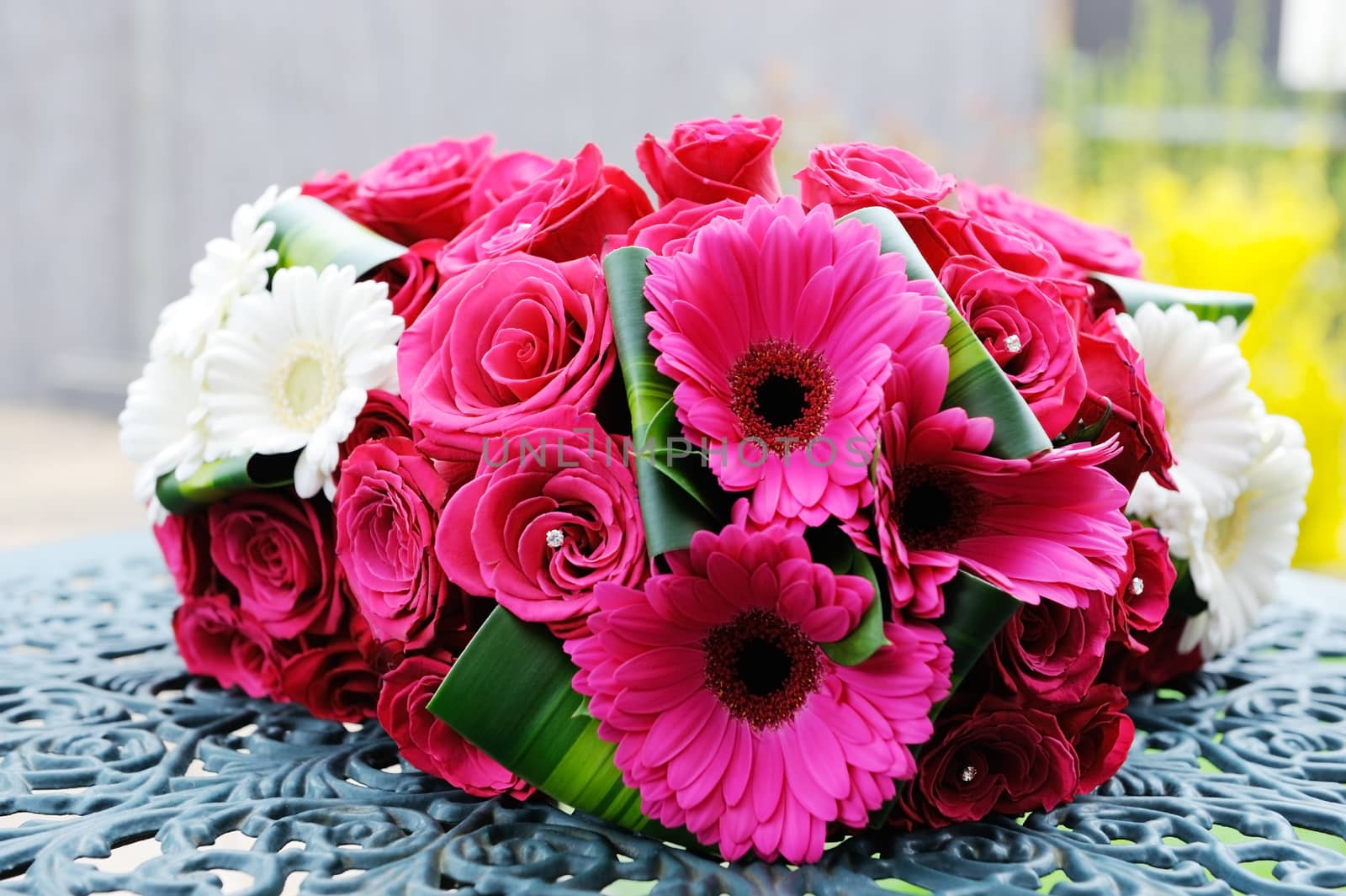 Bride and bridesmaids bouquets closeup are red roses