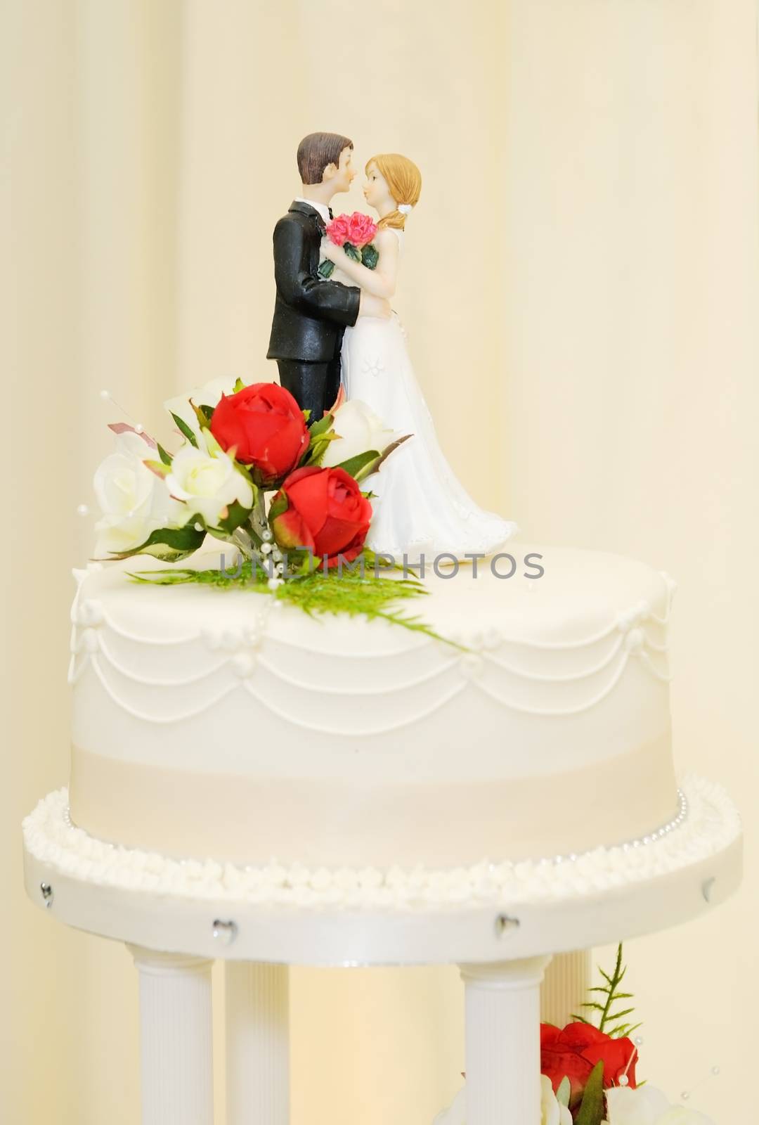 Wedding cake with bride and groom topper closeup detail