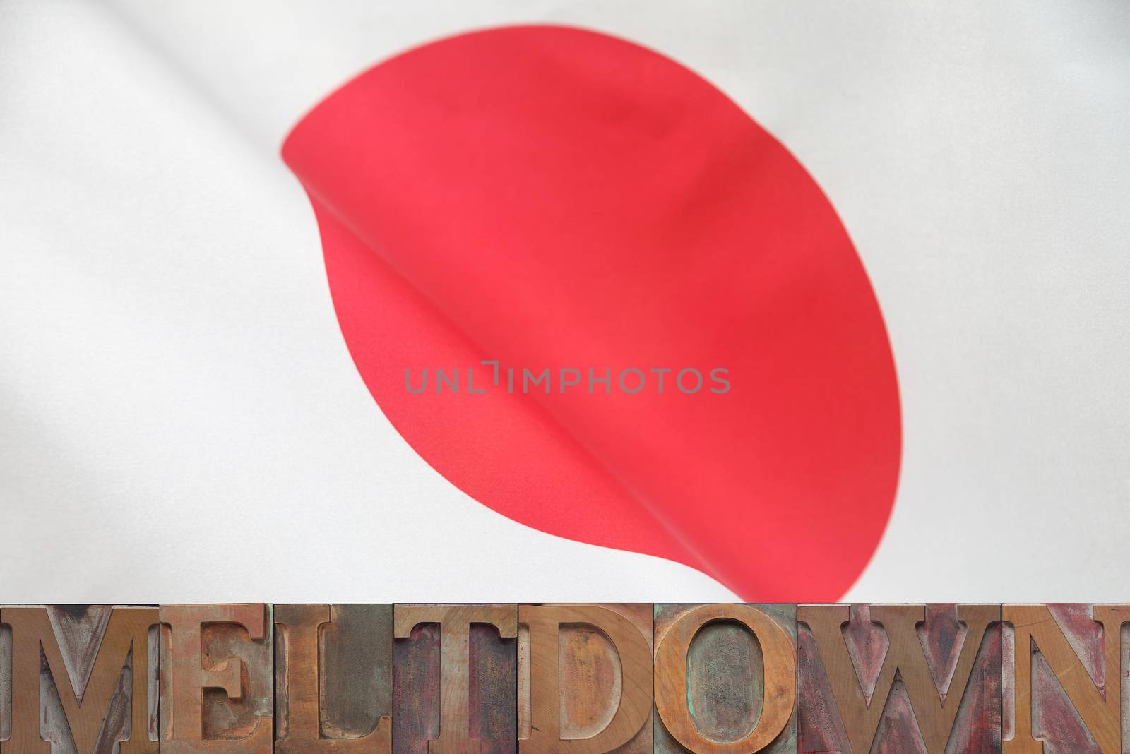 the word meltdown in old wood type on a Japanese flag