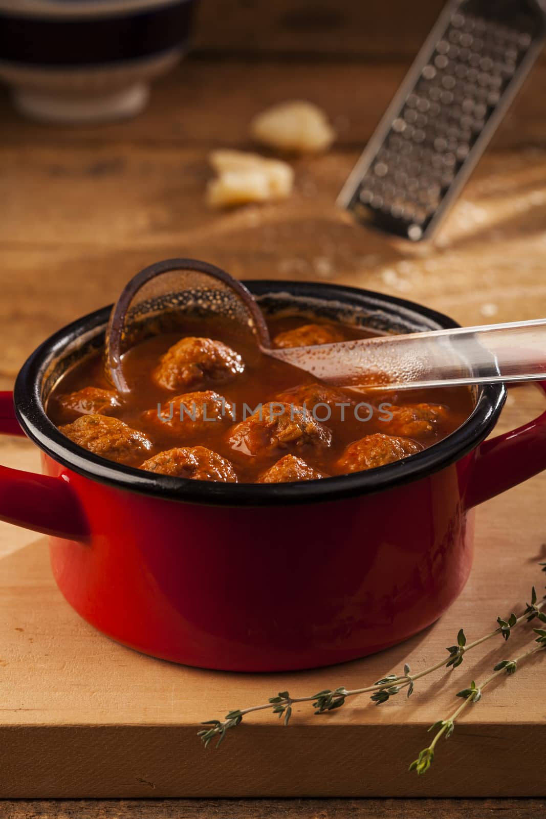 Meatballs in red pan with tomato sauce
