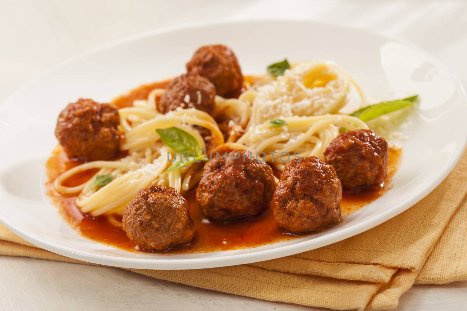 Spaghetti with meatballs with fresh basil and tomato sauce