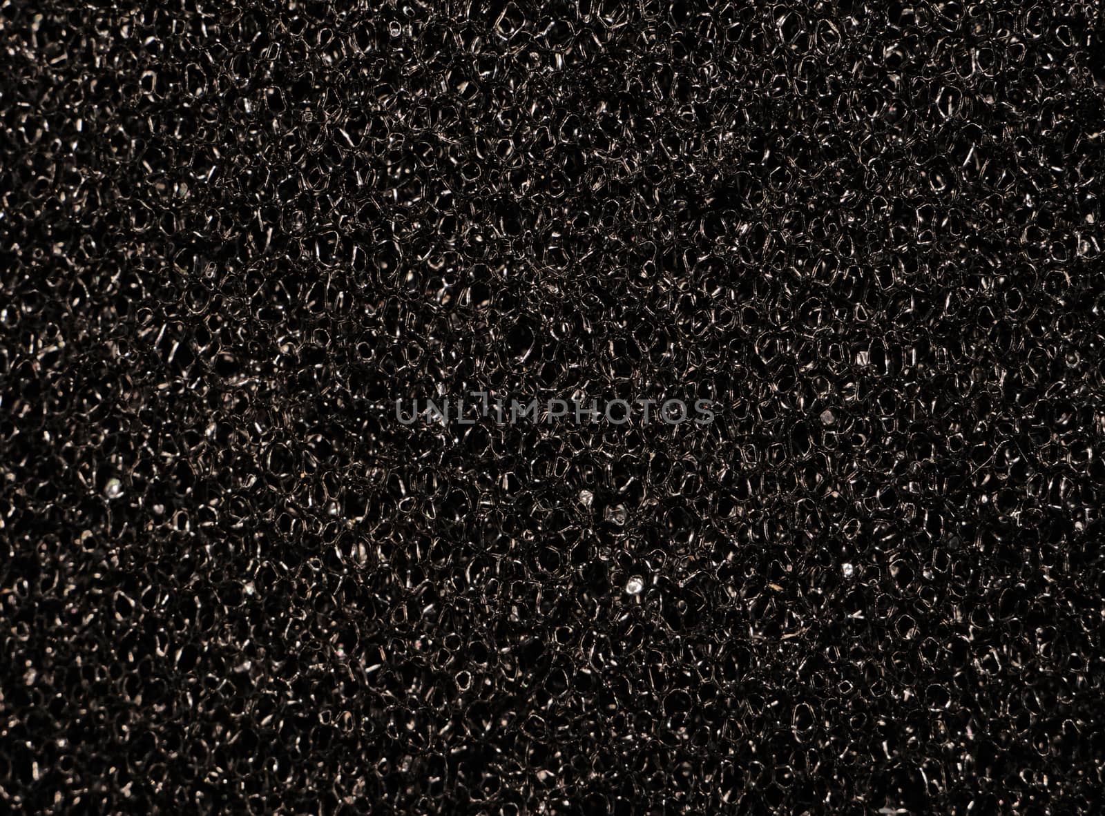 Texture black synthetic porous sponges as background                               