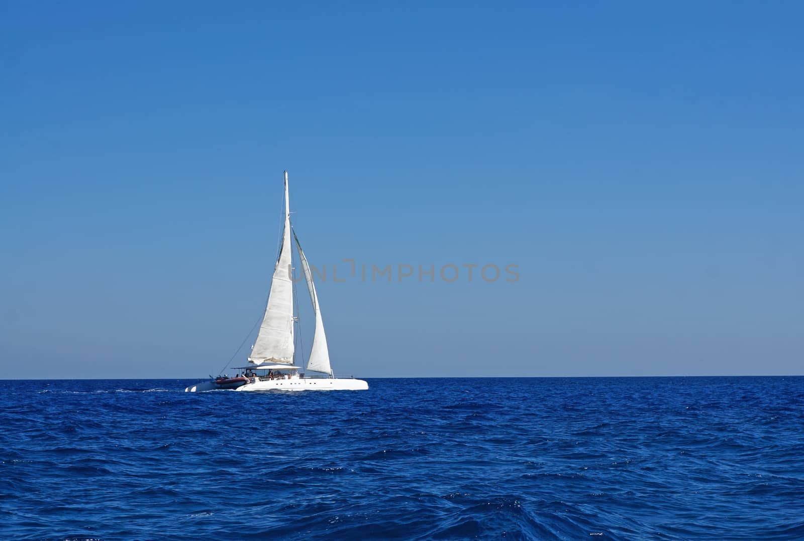 White boat with sails in the Mediterranean                                   