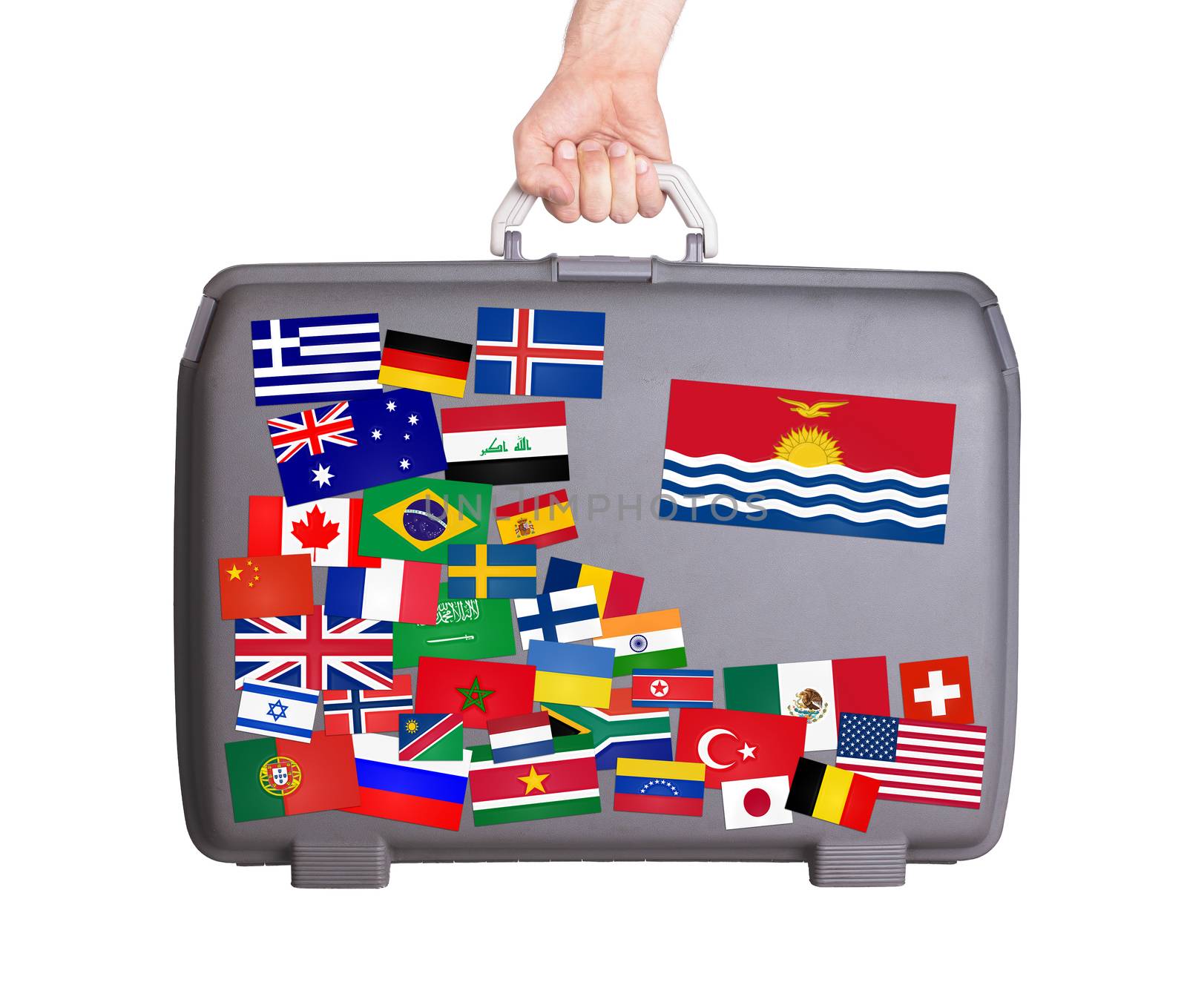 Used plastic suitcase with lots of small stickers, large sticker of Kiribati