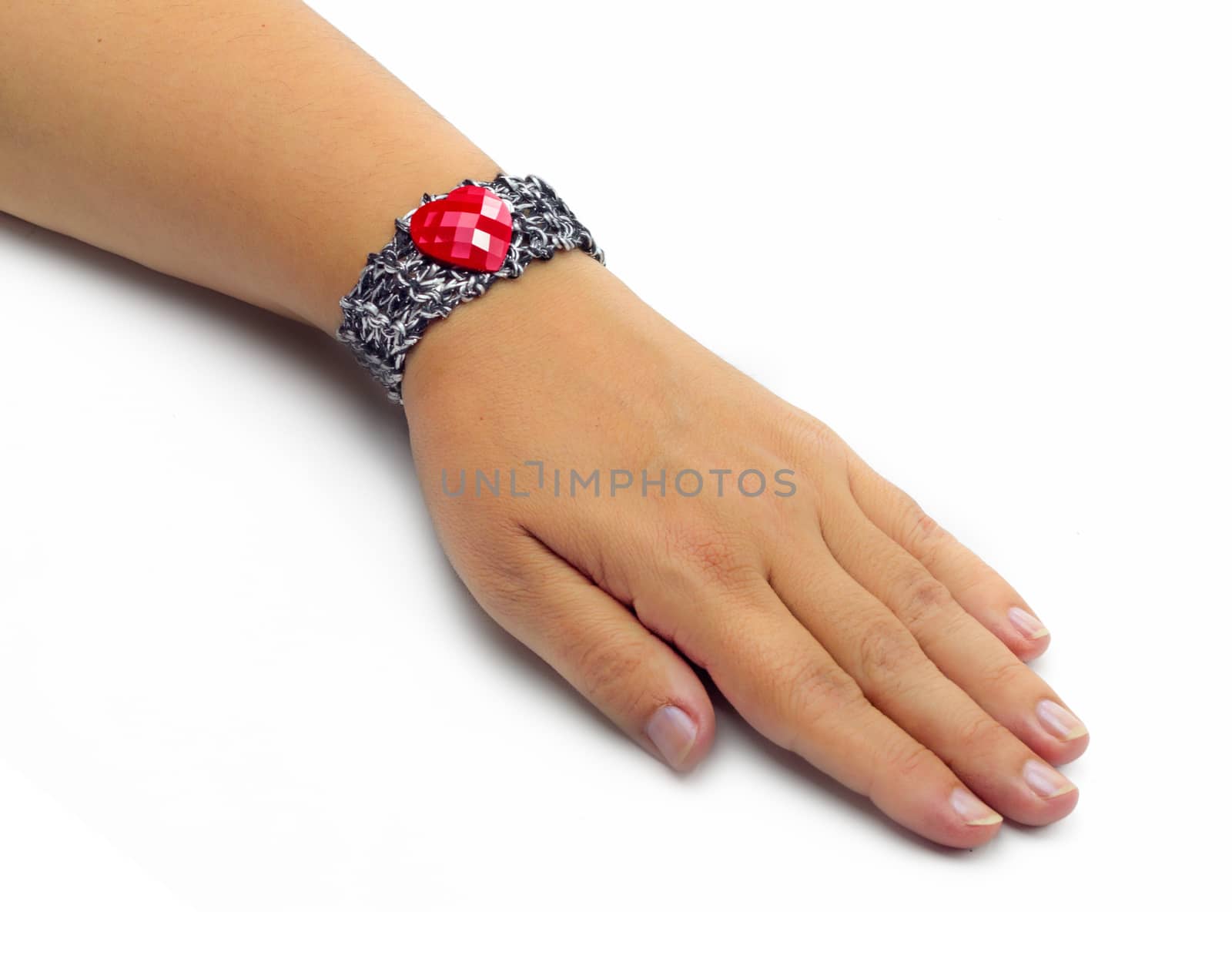 Handmade bracelet with a heart detail on female hand