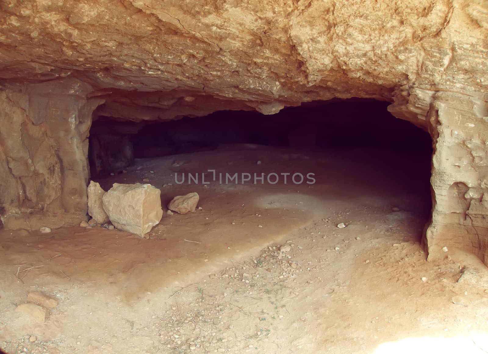 Underground cave entrance and tunnel with sunbeam end shadows