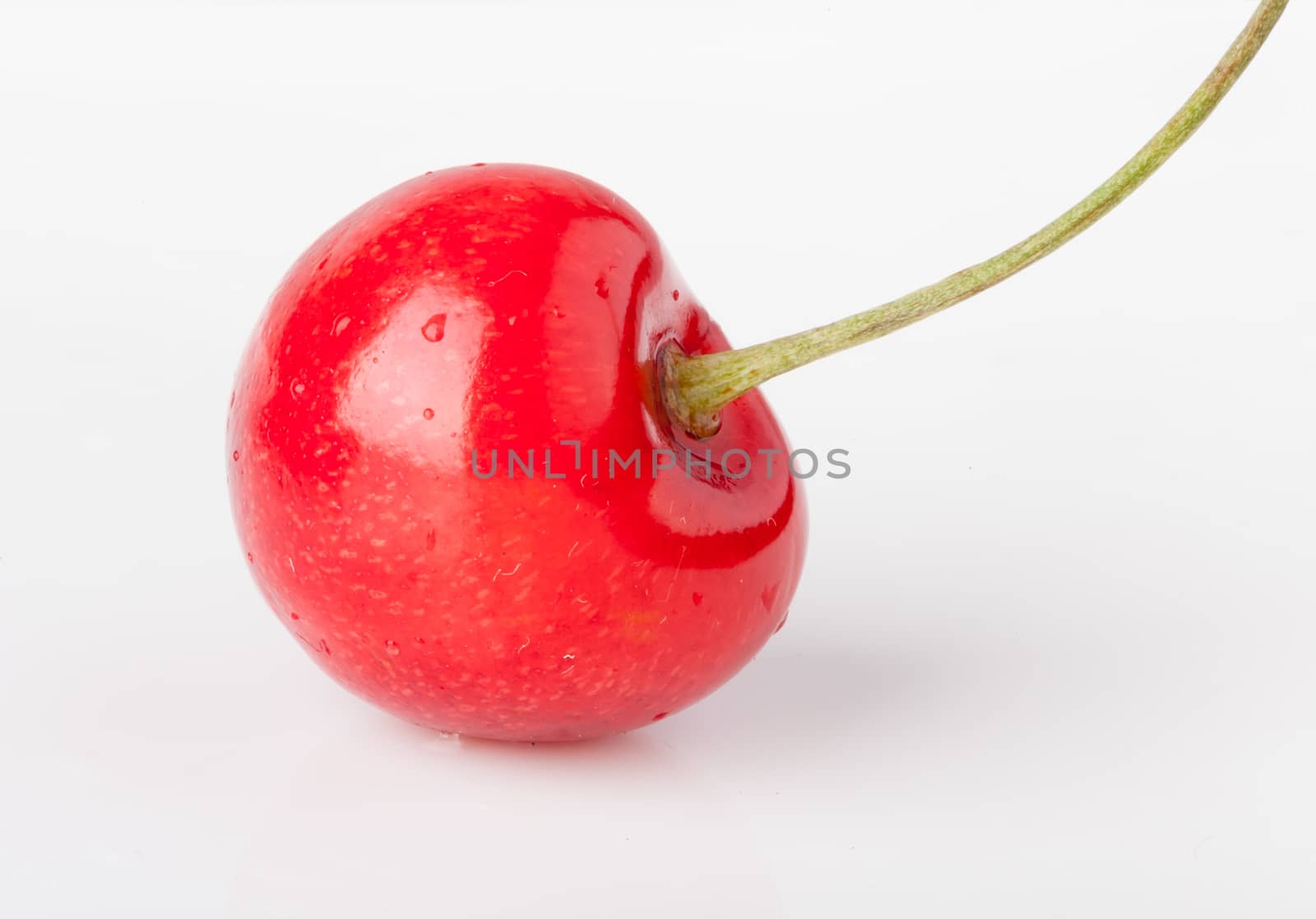 Single cherry on white background